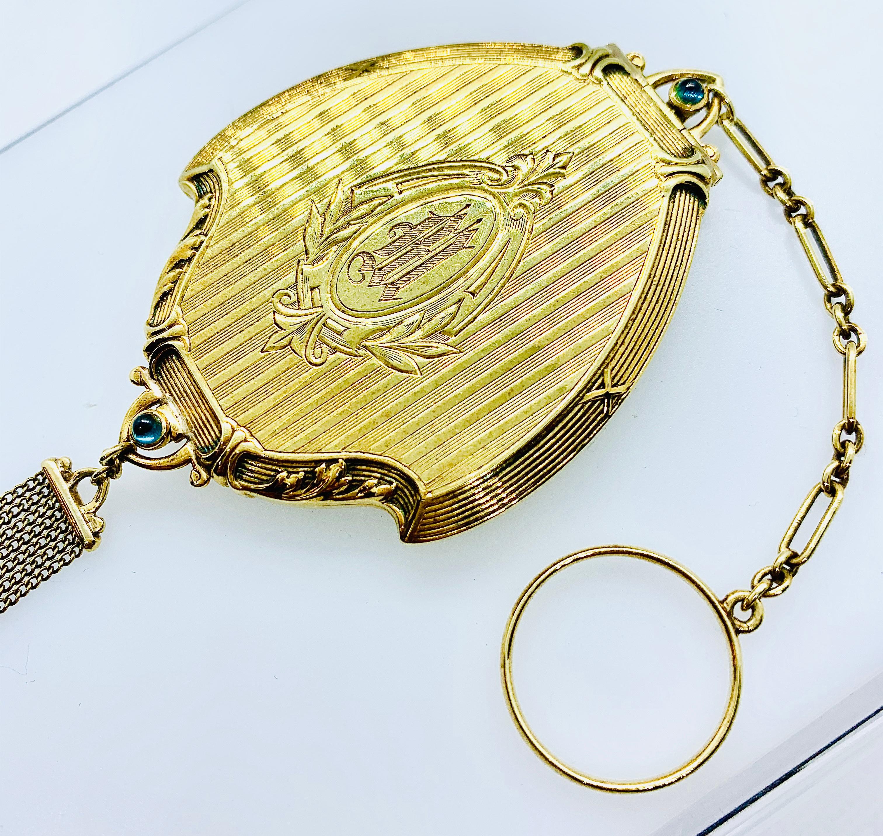 Gorgeous Antique ladies Compact with Mirror. This piece is made in 14K Yellow Gold and features a cabochon sapphire catch and pearl tassel. The piece is engraved not he front 
