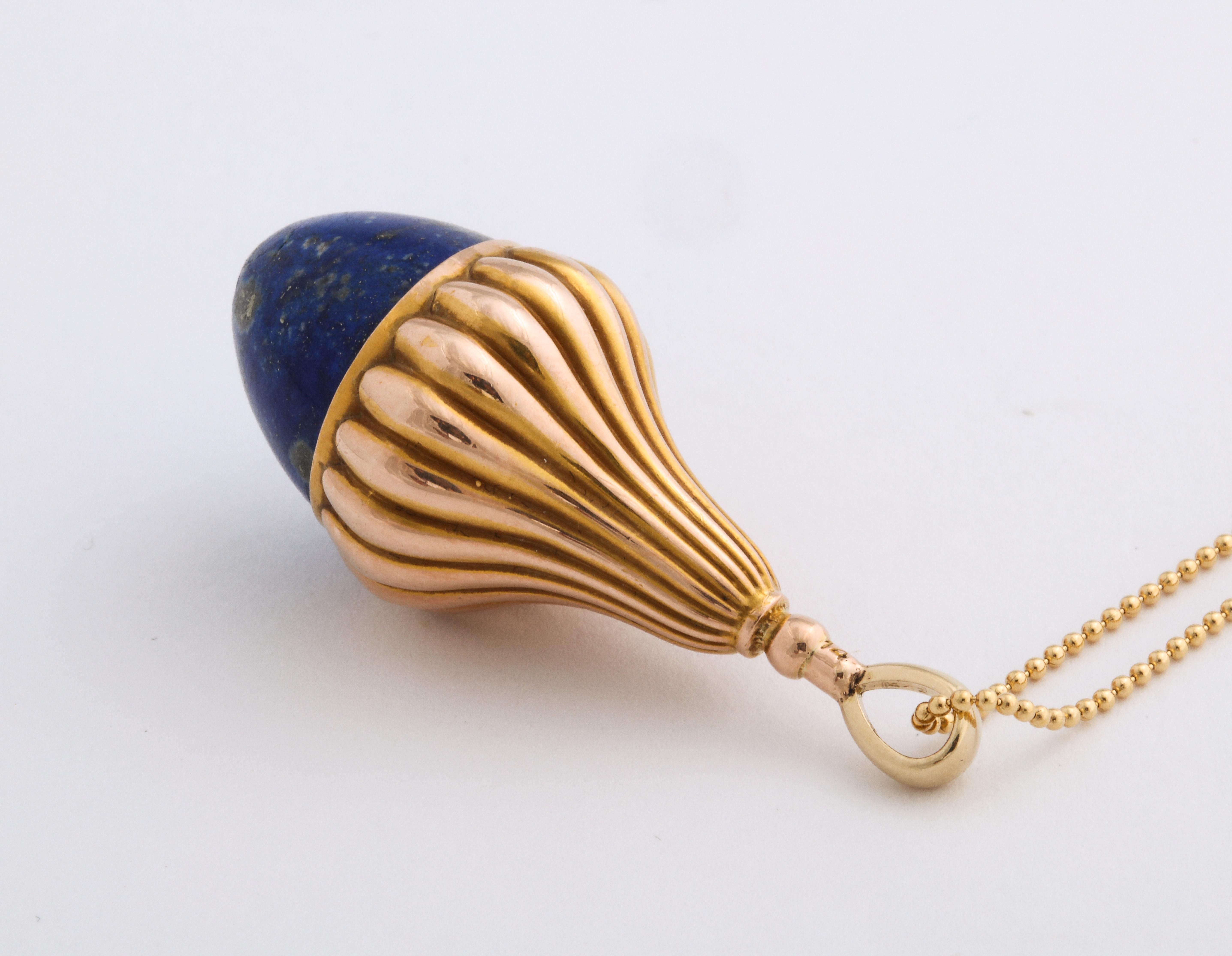 Lapis Lazuli admirers rejoice at this Victorian speckled 7 to 8 ct sugarloaf lapis fob set in a 14 Kt tulip setting. The setting is deeply engraved with ridges. The fob can be worn on a chain at the neck together with other items or it can be added