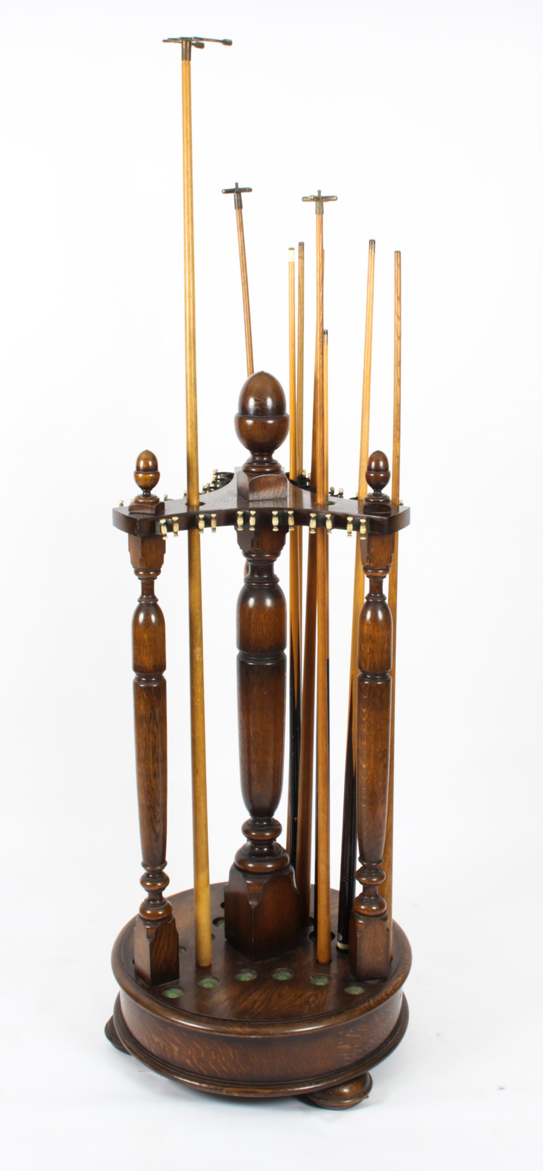 A fine and rare large revolving oak snooker cue stand, late 19th century in date.
 
The circular base revolves to make selecting cues easy and is sitting on three bun feet with turned columns surmounted by acorn finials, racked for 18 cues plus 3