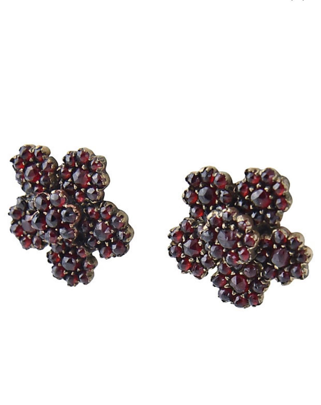 Victorian garnet and base metal flower earrings mounted on to 14k yellow gold posts.  They come with a pair of plastic wide backs to keep them nicely placed on the ear.