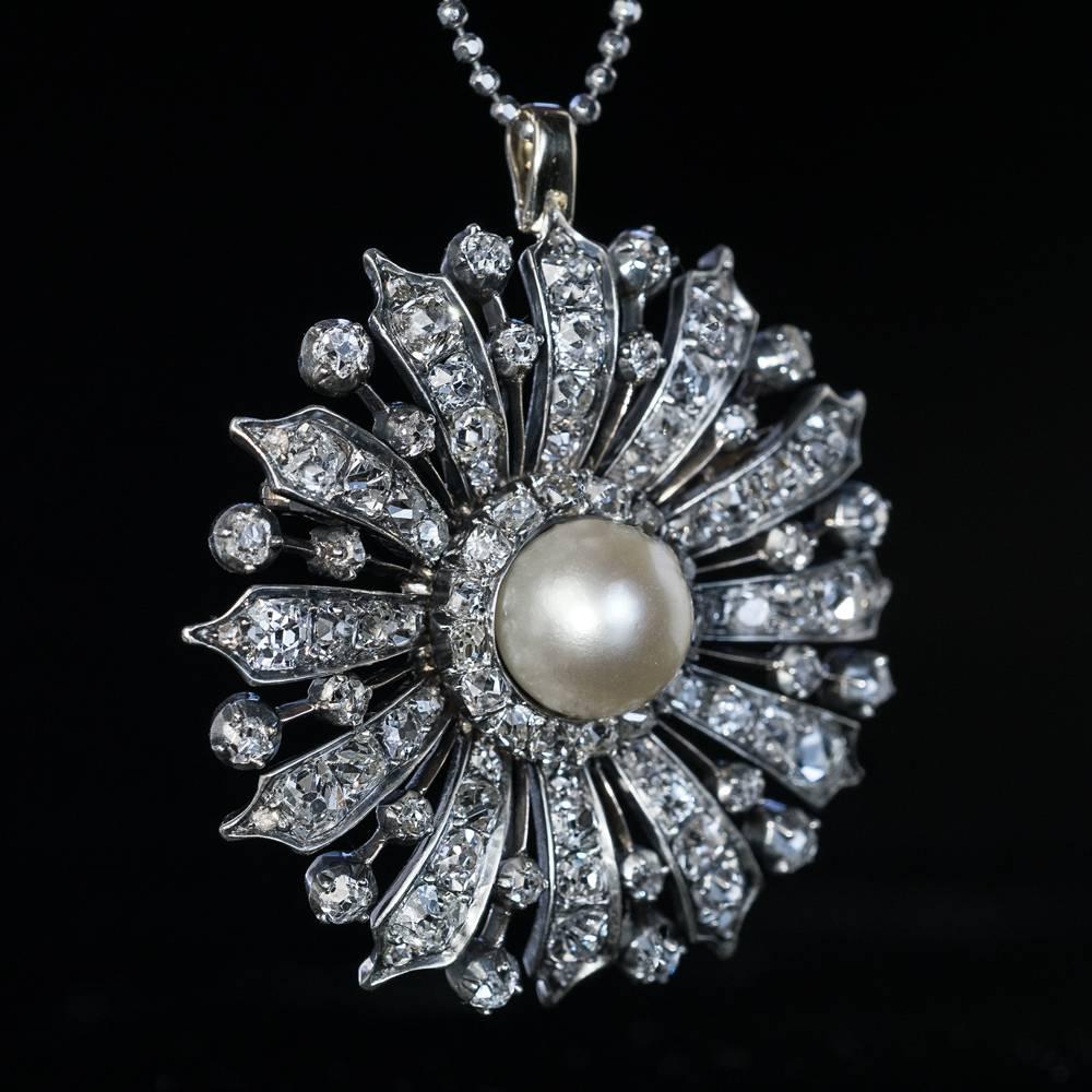 Circa 1870

A finely crafted in silver-topped gold (front – silver; back – gold) Victorian era brooch / pendant is designed as a stylized flowerhead, centered with a large (10 mm) natural saltwater pearl surrounded by chunky old cut