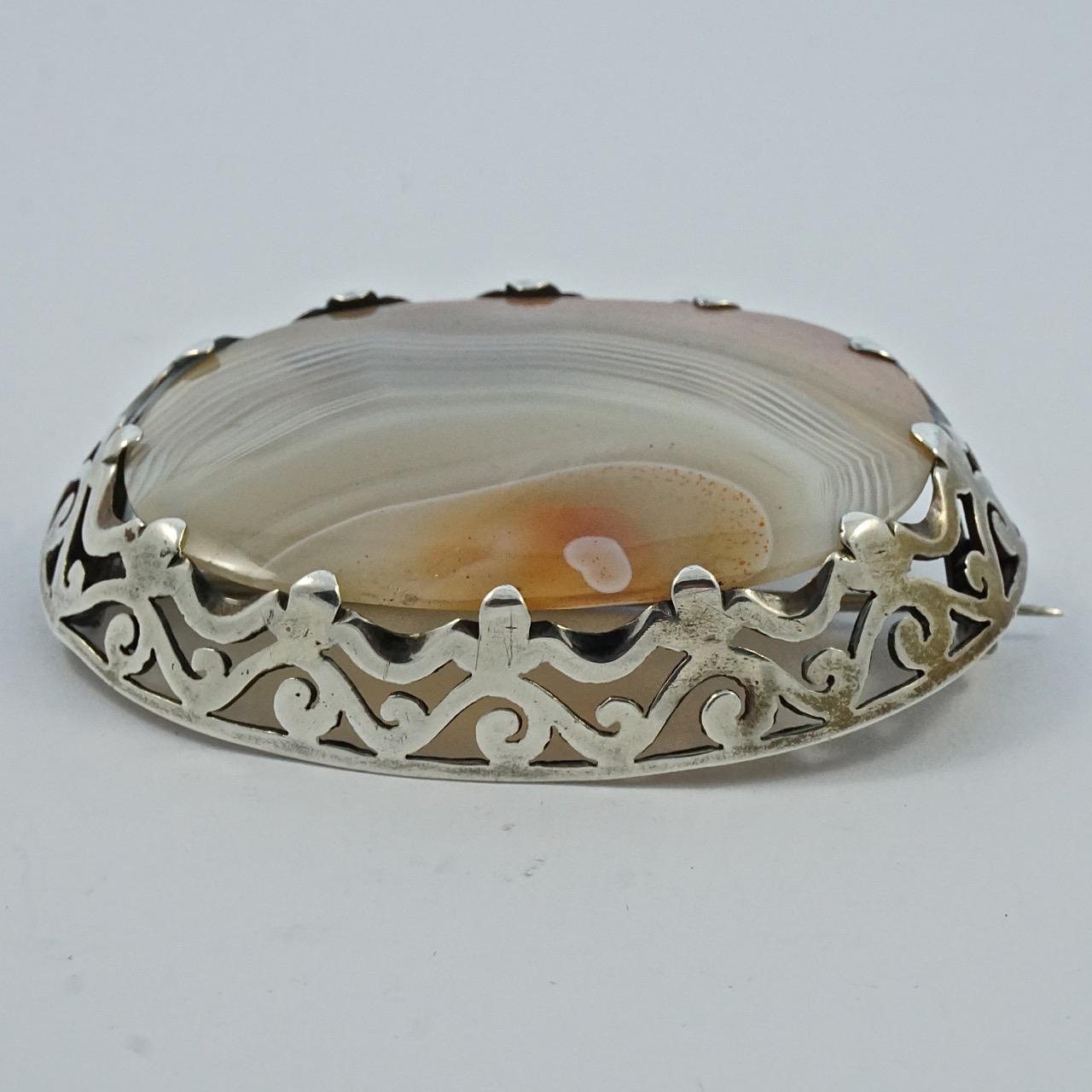Wonderful antique Victorian large agate brooch, with a decorative swirl design edging. The brooch tests for silver and has the old 