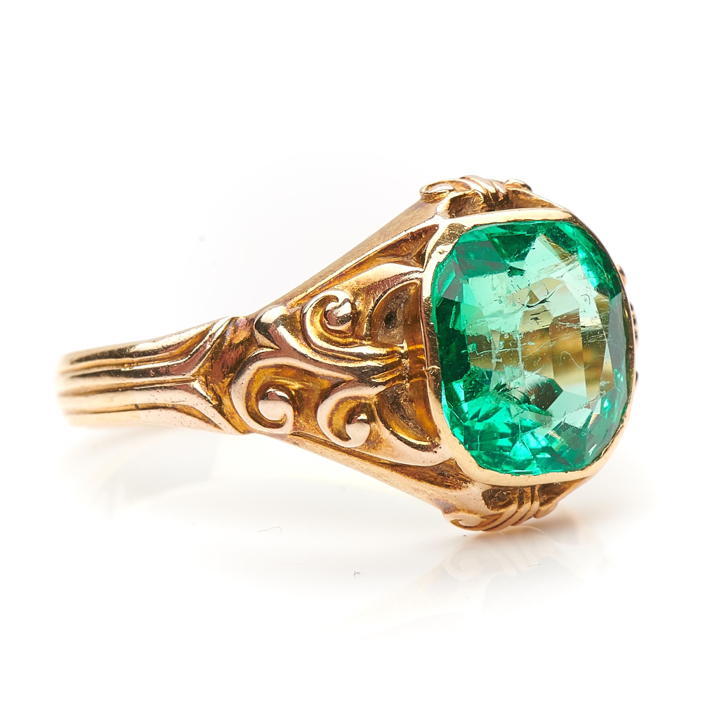 Victorian, single emerald ring, circa 1880. A fabulous vibrant green certified Colombian 3ct emerald set in heavy beautifully carved gold shoulders. The emerald is fairly clear which is rare given the size and nature of this stone. The best emeralds