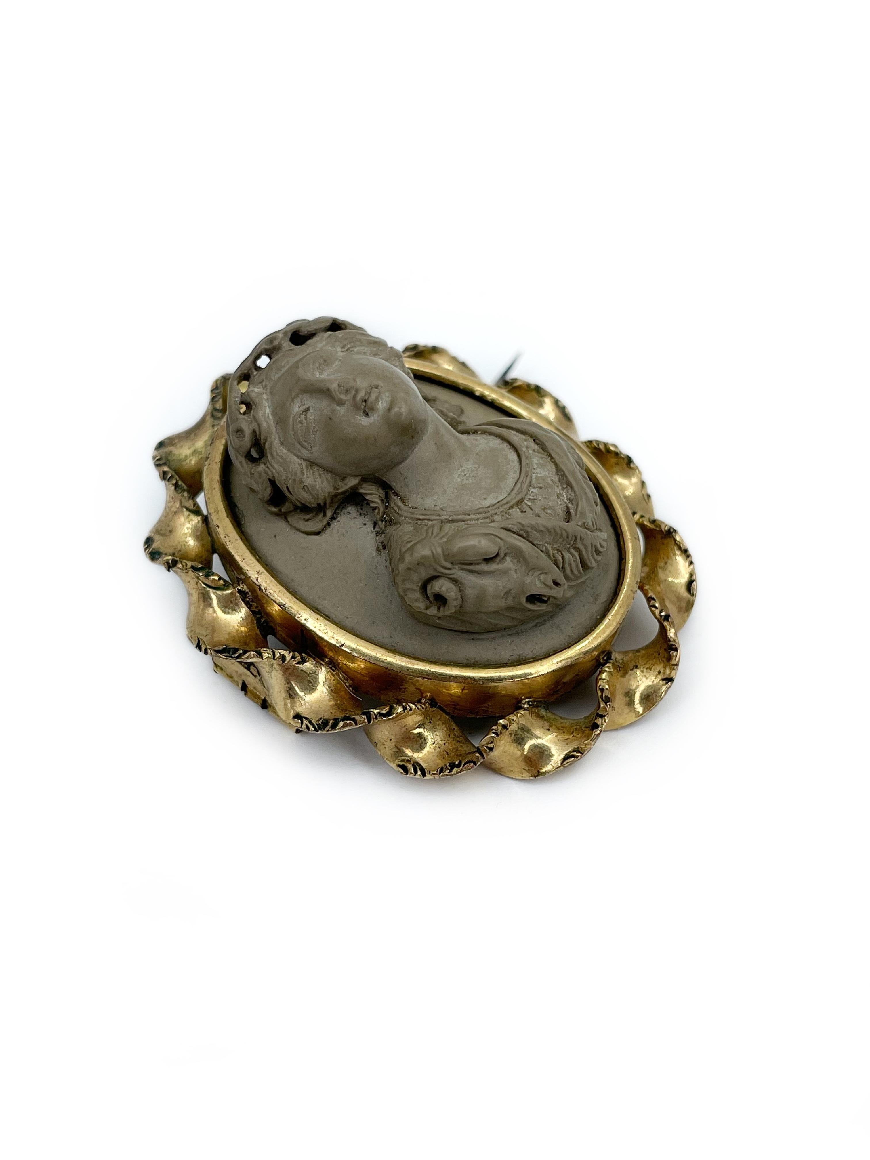 This is a stunning antique Victorian oval gold-filled cameo brooch. Circa 1850. The cameo is carved from lava and depicts a lady facing left. 

This is a real a real treasure not only for unusual material but also because left facing cameo are much