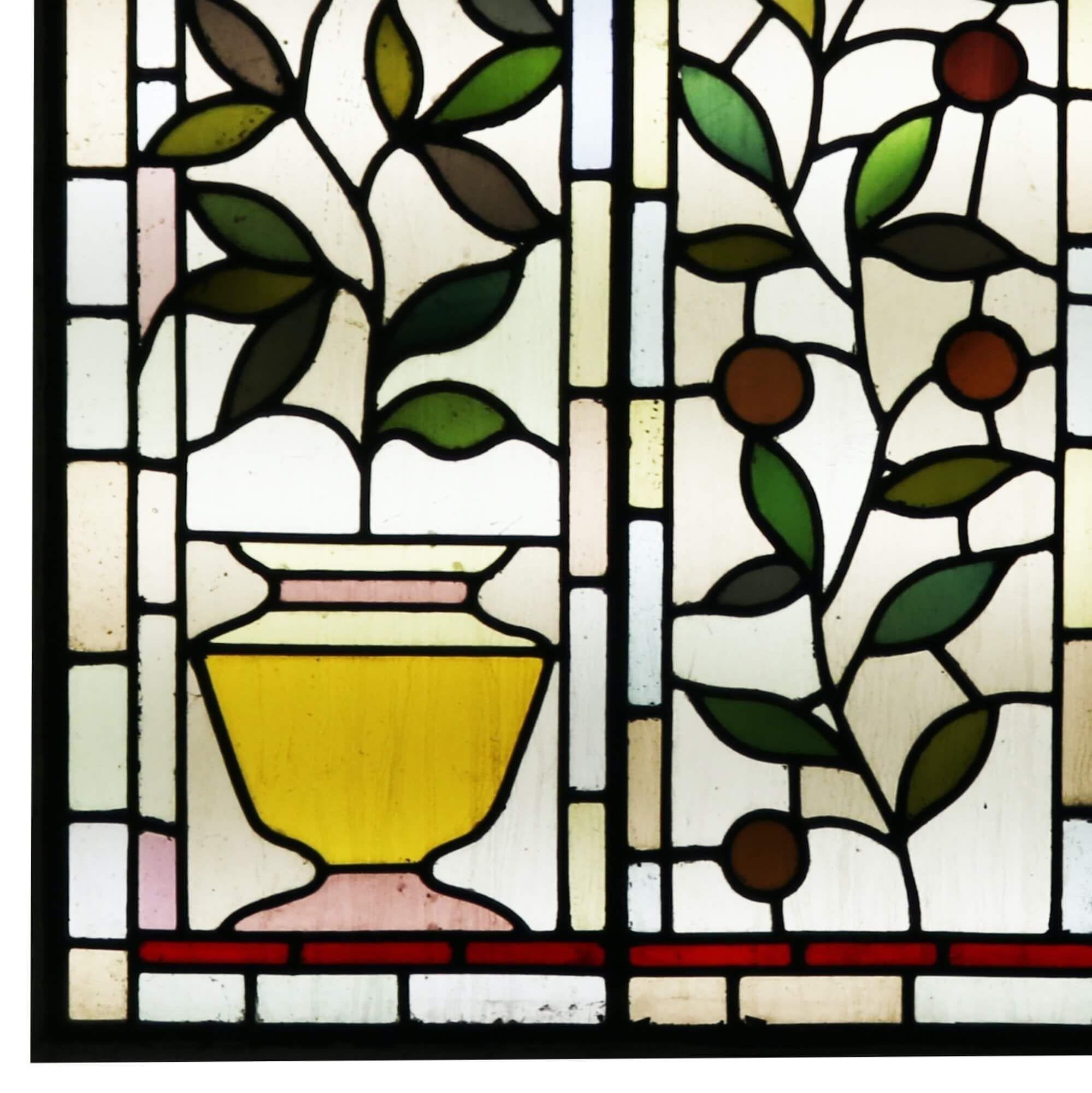 A large antique Victorian stained glass window over 1m tall depicting orange and lemon plants in pots circa 1890. You can just imagine this gorgeous stained glass as a feature window in a Victorian or period property, the vibrant yellows, red,
