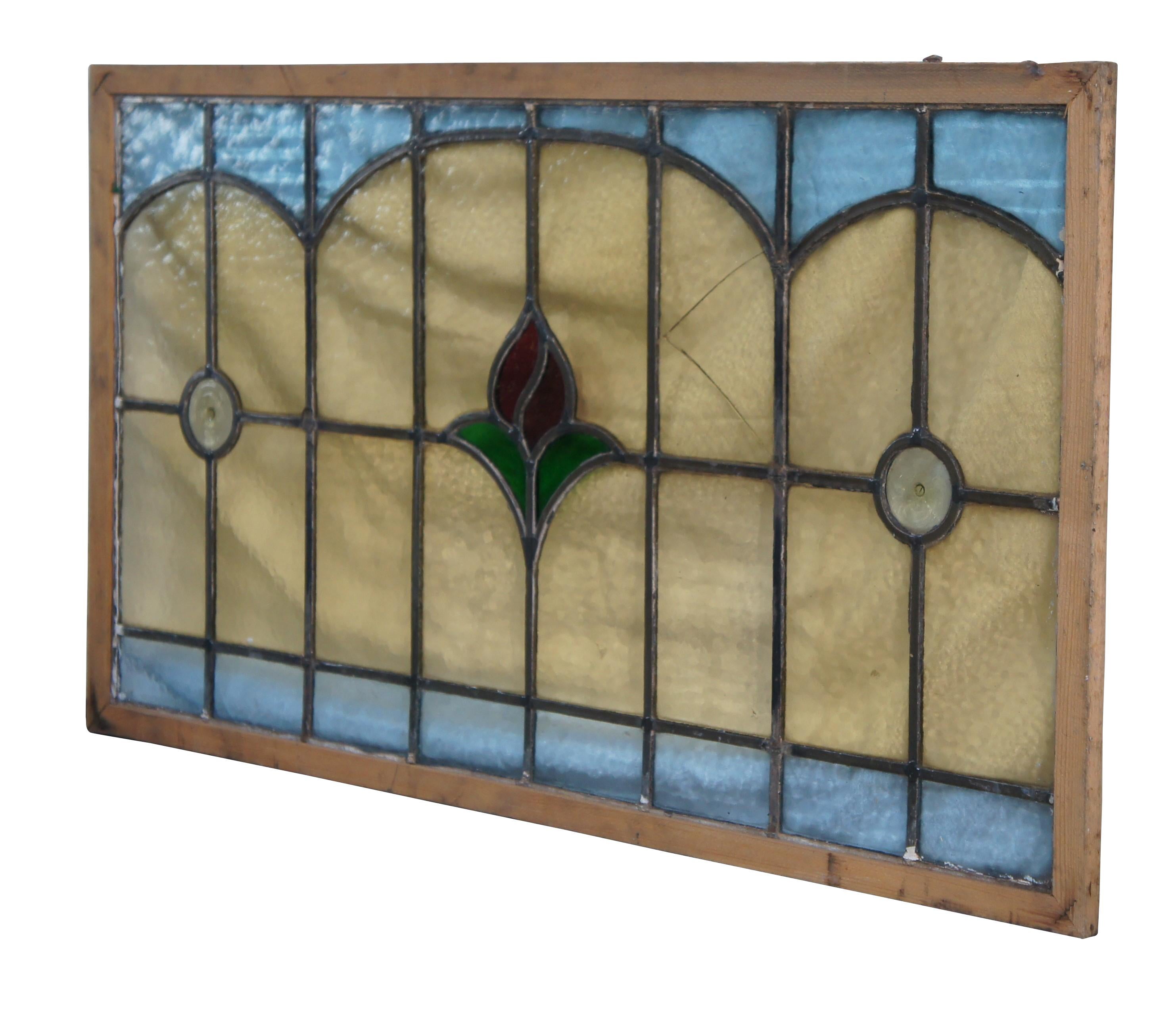 A beautiful late Victorian antique leaded stained glass window.  Features a gridded frame with yellow outline at the center around a blossoming rose.  Framed in wood

Dimensions:
21