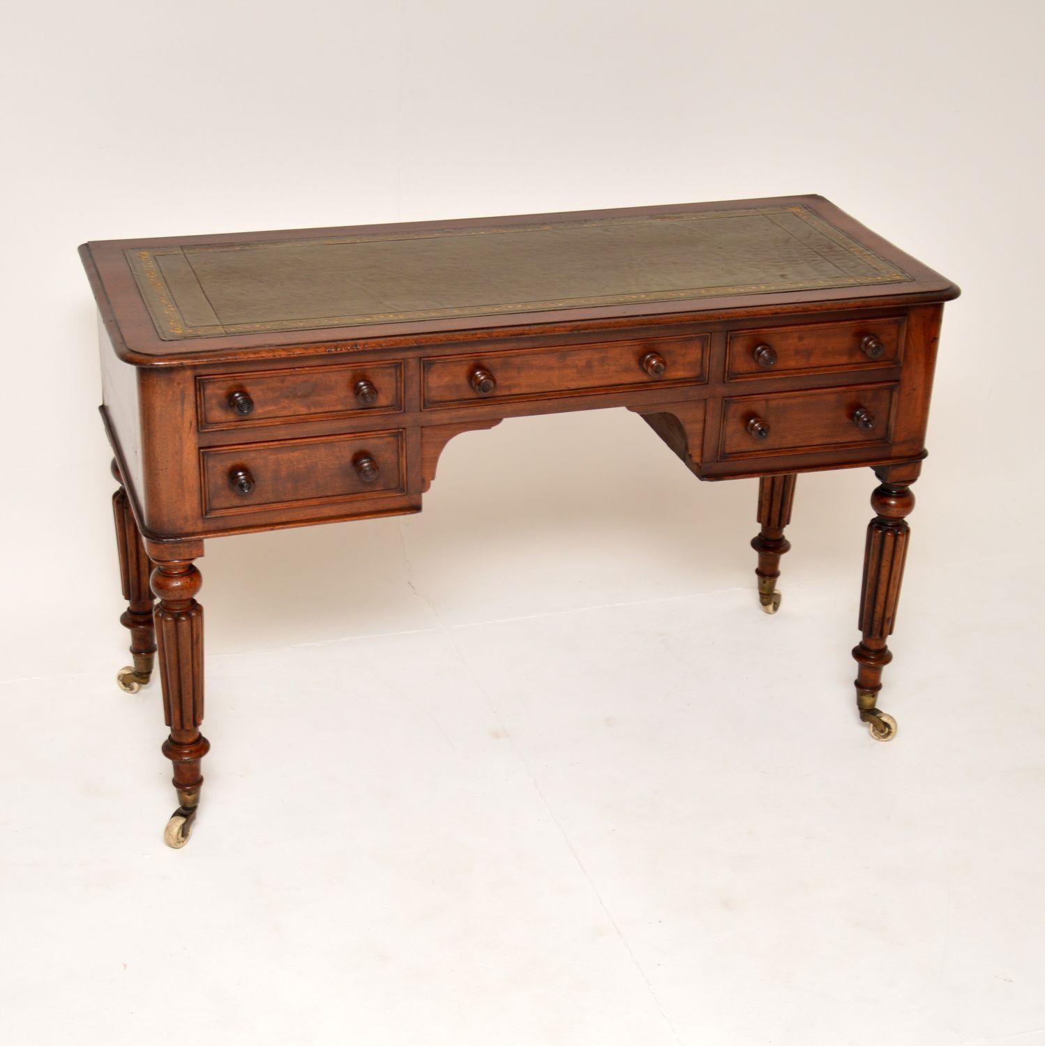 An excellent antique Victorian leather top desk. This was made in England, it dates from the 1840-1860 period.

It is of amazing quality, it sits on fluted baluster legs on original white porcelain casters. The drawers have nicely turned wooden