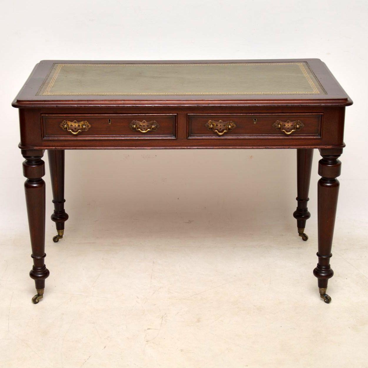 Antique Victorian leather top mahogany writing table in good condition and dating from around the 1860s-1880s period.
This desk has a tooled leather writing surface, a polished back, two drawers with locks and original brass handles, turned legs