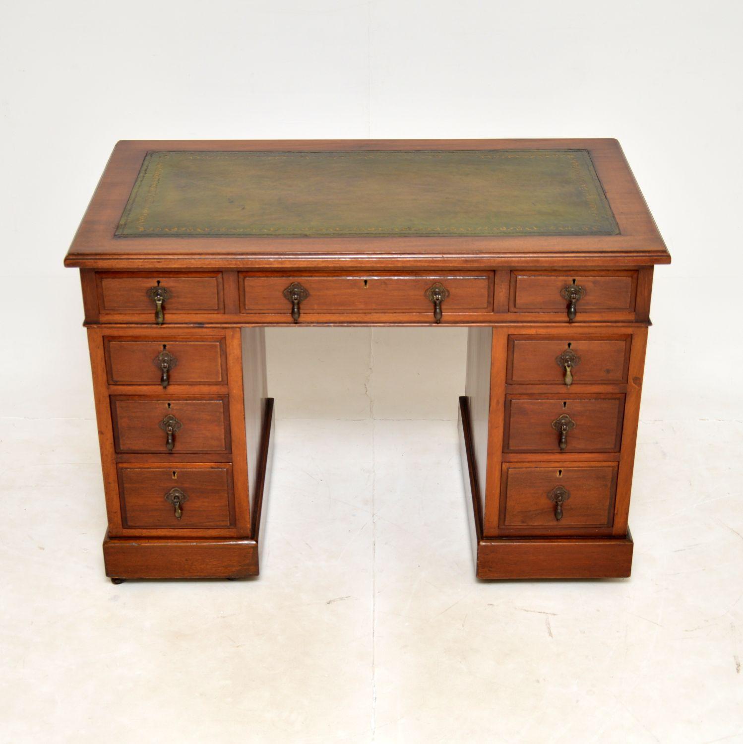 A smart and very well made antique Victorian pedestal desk. This was made in England, it dates from around the 1870-1890 period.

It is of lovely quality and is a very useful, petite size. The drawer fronts have brass tear drop handles, this sits on