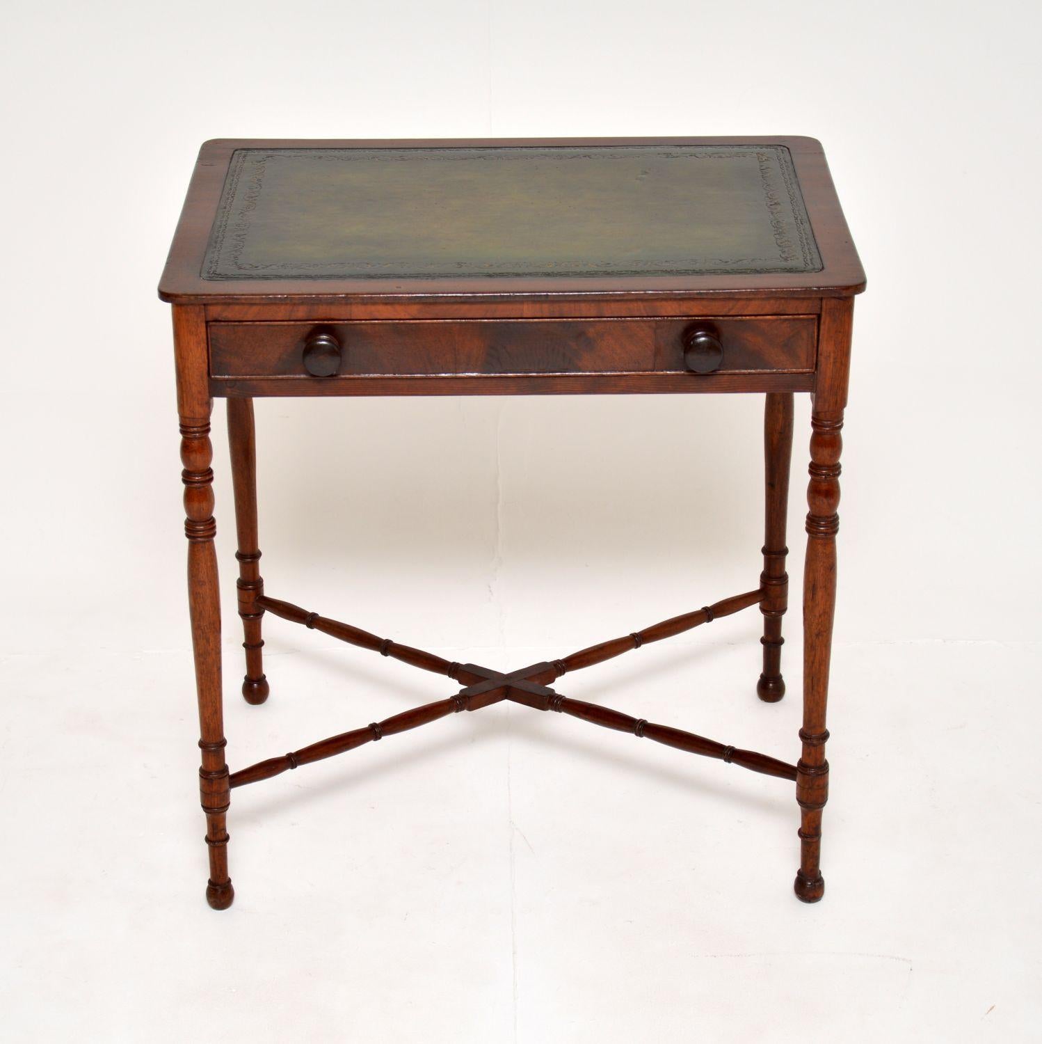 A charming antique Victorian writing table. This was made in England, it dates from around the 1860-1880 period.

It is a lovely size, fairly small and compact with a good sized working surface. The inset leather top is hand coloured and gold