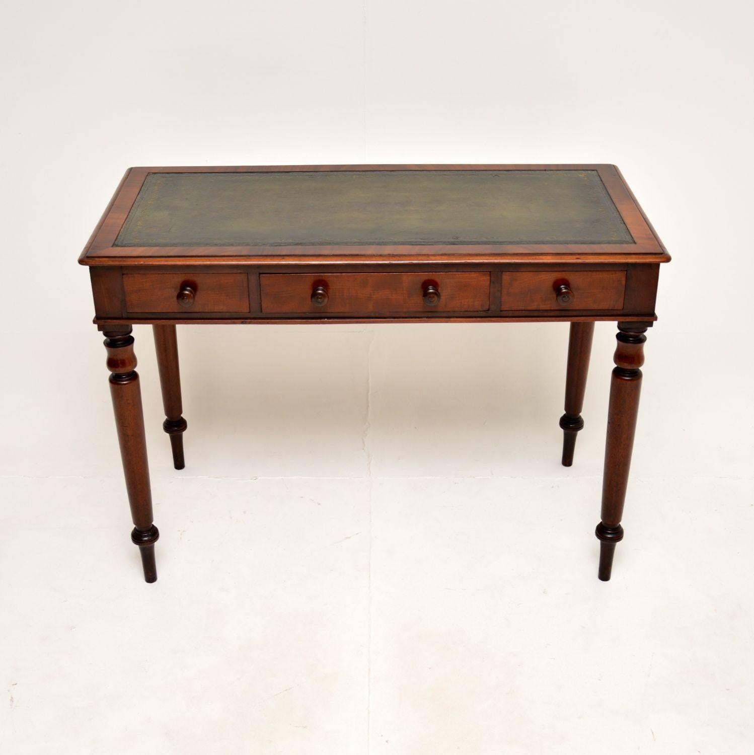 A superb antique Victorian leather top writing table / desk. This was made in England, it dates from around the 1860-1880 period.

It is of fantastic quality and is a very useful size. It sits on beautifully turned legs and also has lovely turned