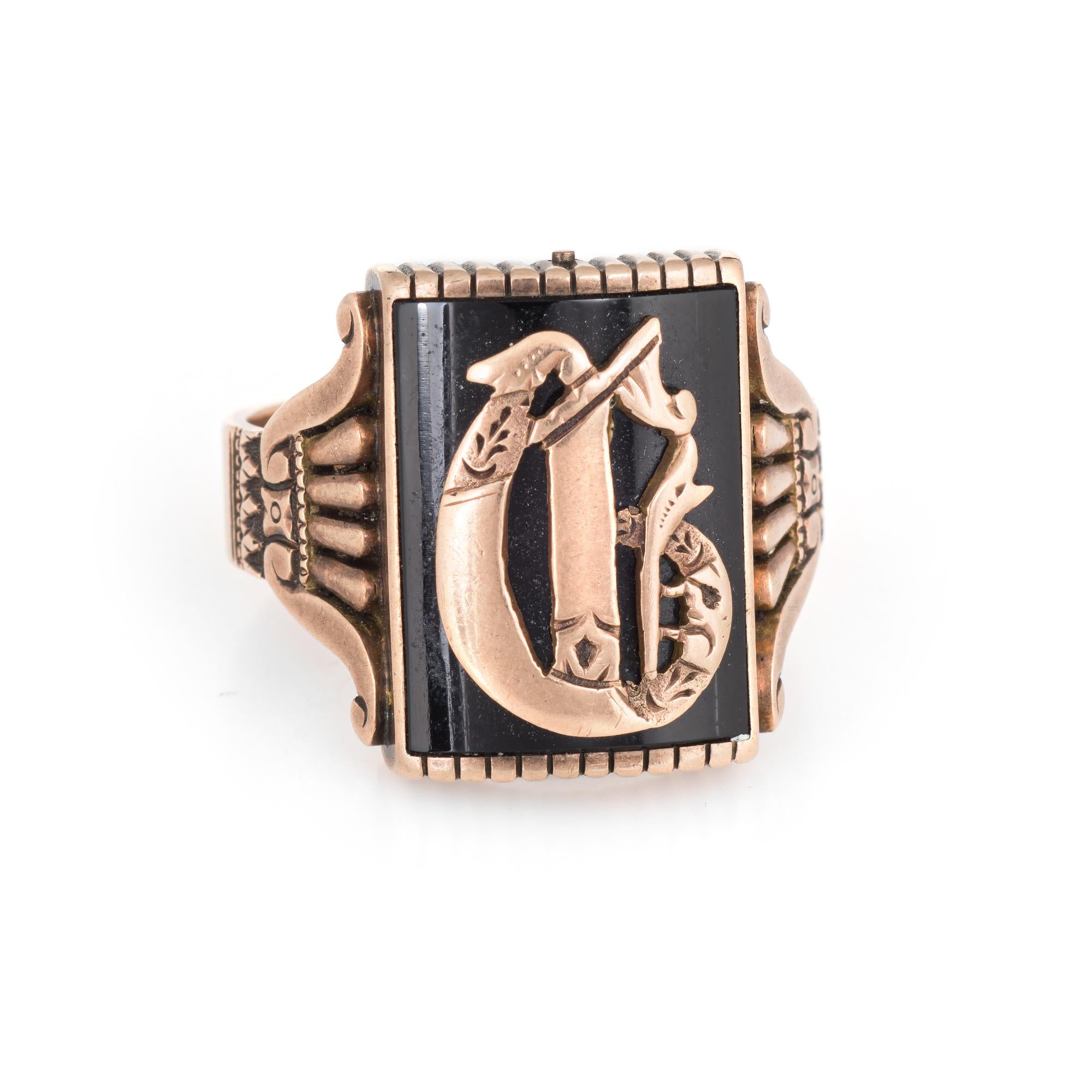 Finely detailed Victorian era signet ring (circa 1880s to 1900s) crafted in 14 karat rose gold.

The initial is set upon a black onyx mounting that measures 17mm x 13mm.

The handsome ring features scrolled detailing to both side shoulders. The