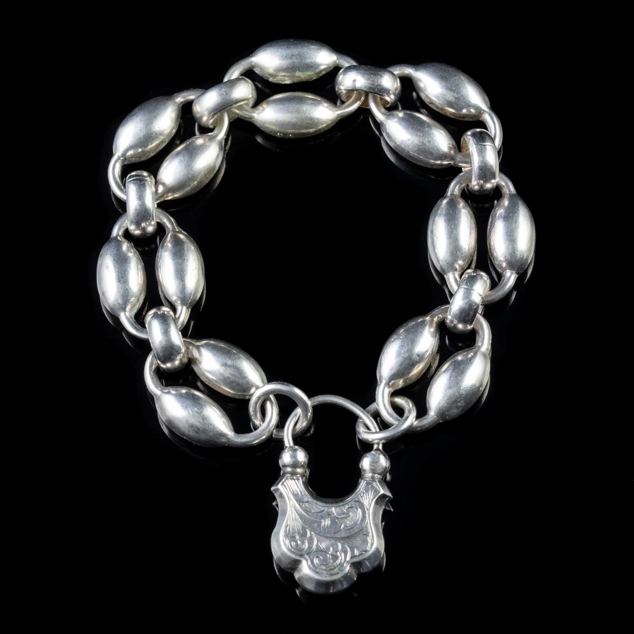 This beautiful Antique Victorian bracelet has been modelled in Silver and features large links with a bubble style design to them. 

To close the bracelet it features a large engraved clasp in the shape of a padlock which also houses a locket window