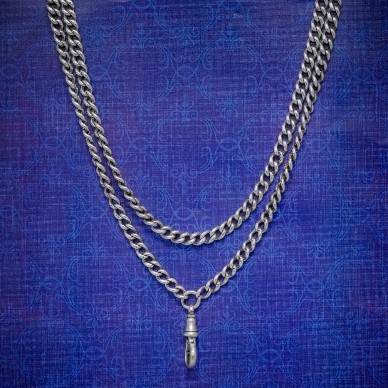 This solid, late Victorian guard chain is made up of strong Sterling Silver links each baring a Lion hallmark for Sterling Silver. 

The chain is complete with a ring clasp at the end which may have been used to attach a pocket watch or a cylinder
