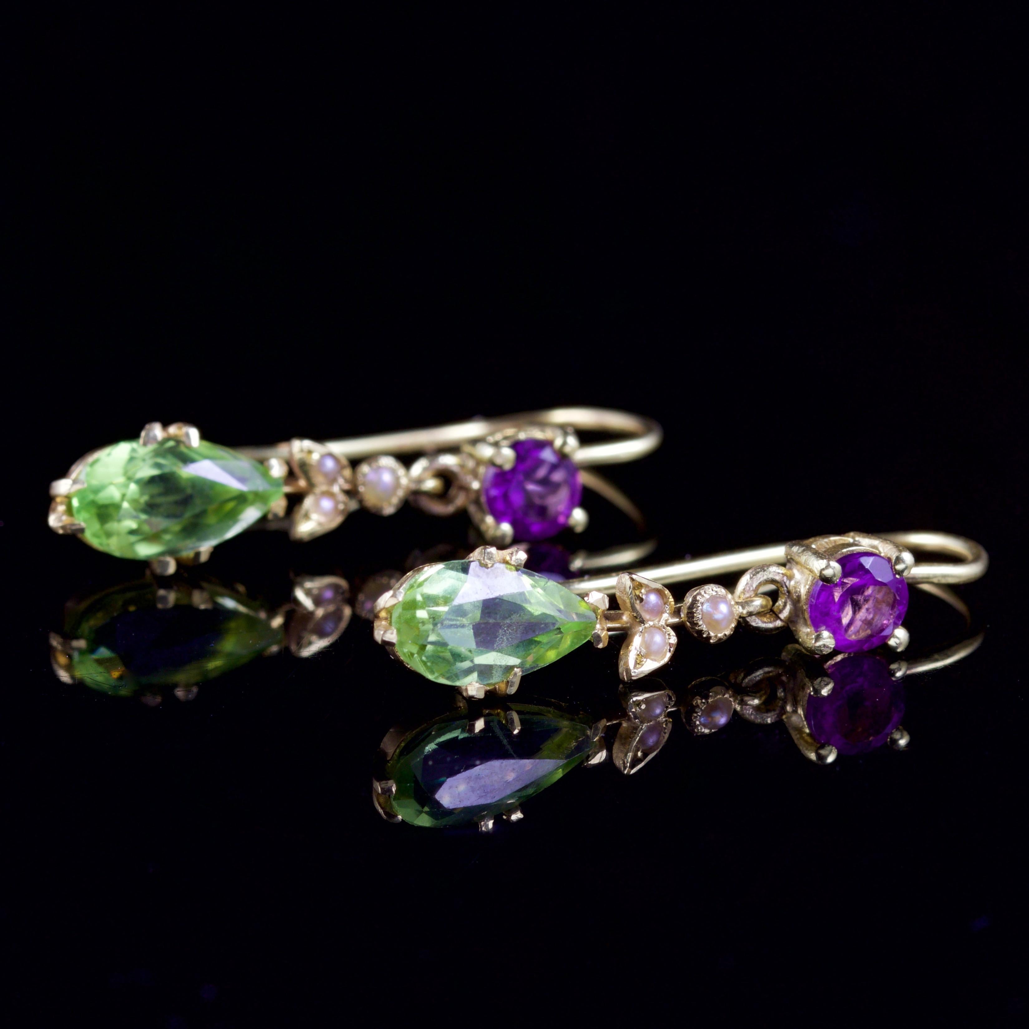 These superb Suffragette drop earrings are Victorian, Circa 1900. 

Each earring is adorned with an Amethyst which leads down to three creamy Pearls and a beautiful green, Peridot dropper which is 0.65ct.

Suffragettes liked to be depicted as