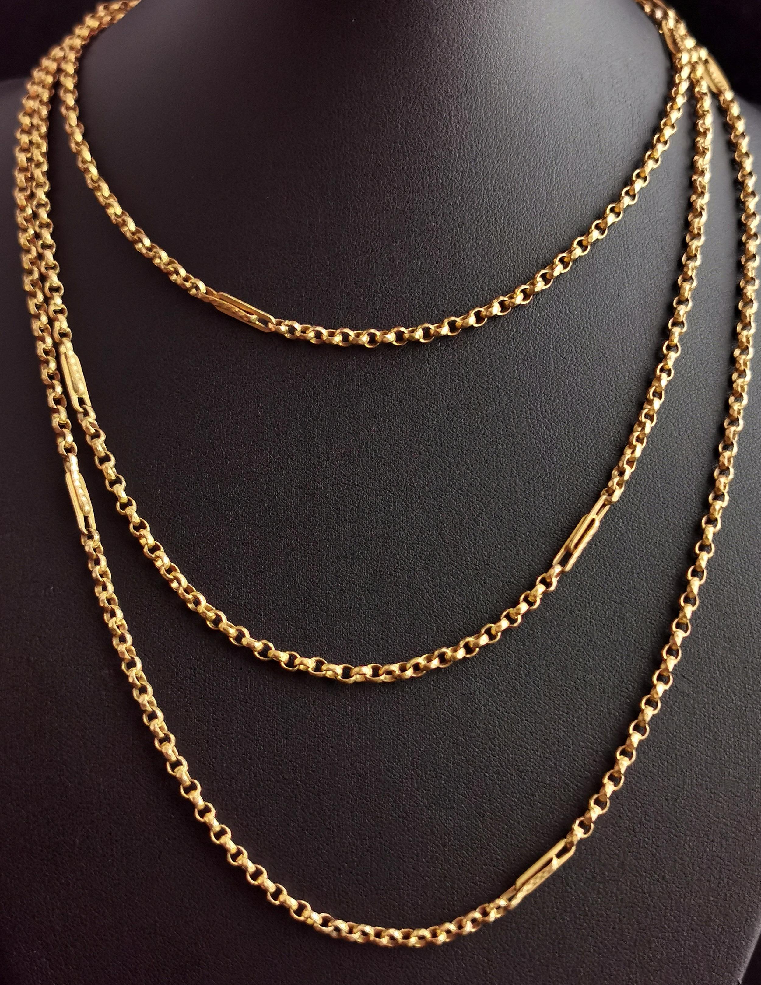 A gorgeous antique, Victorian era gold plated longuard chain or muff chain.

Rich golden, faceted rolo links intercepted with fancy interlocking paperclip type links.

It has that lovely rich old gold tone only to be found on older pieces.

A