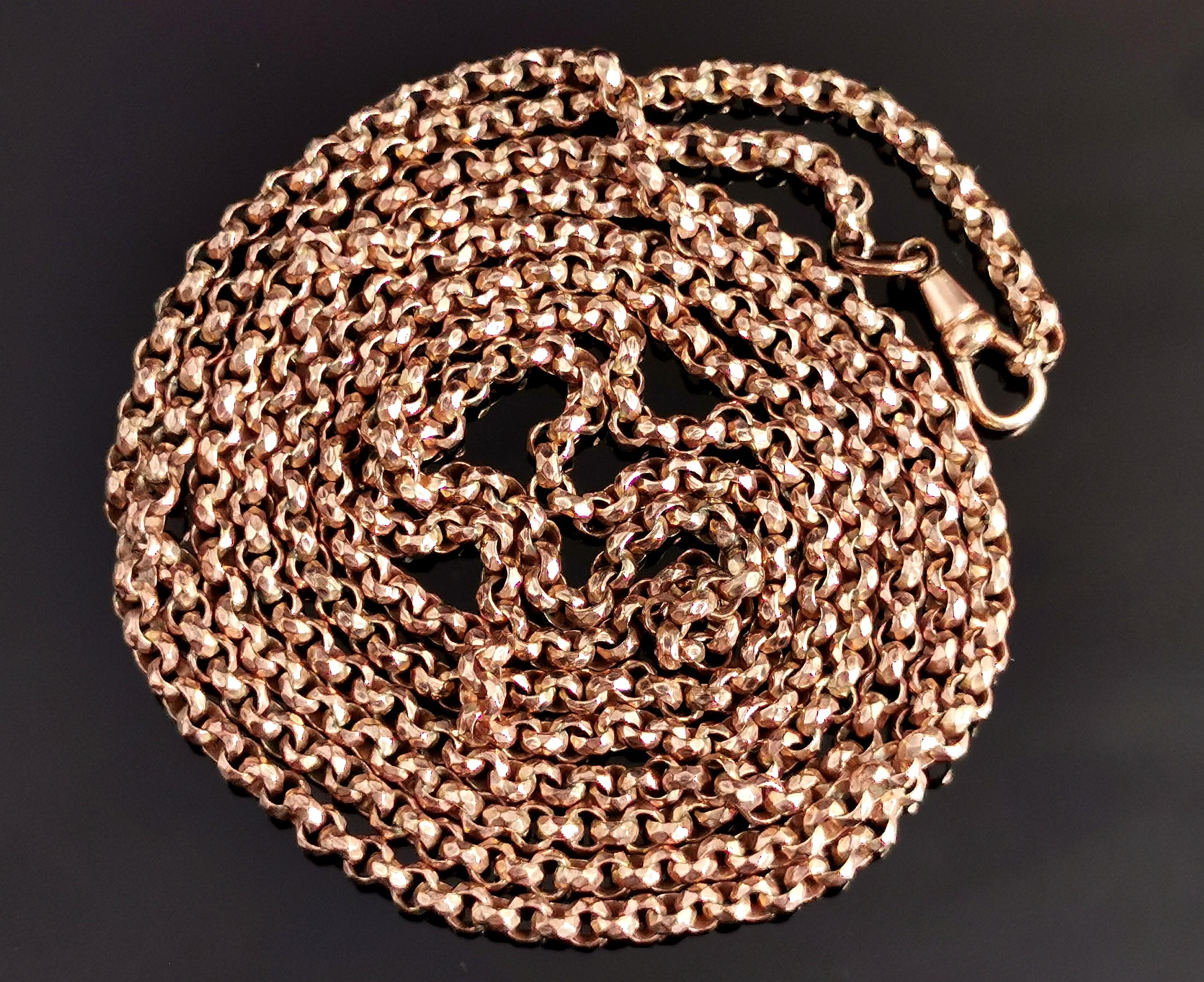 A beautiful antique Victorian era rose gold plated longuard chain necklace.

It has fancy shaped and engraved rolo style links with a rose gold plating and a dog clip fastener for adding your perfect accompaniment.

A universal chain, can be worn