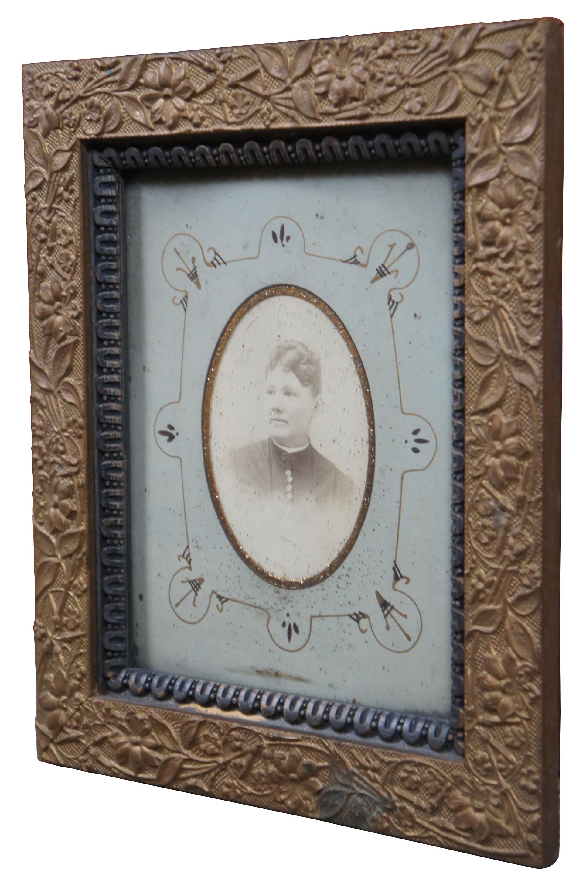 Antique late 19th century Victorian gilt wood carved photo frame containing a photograph of a woman.

Measures: 11.75” x 1” x 13.75” / sans frame - 7.75” x 9.75” (width x depth x height).
