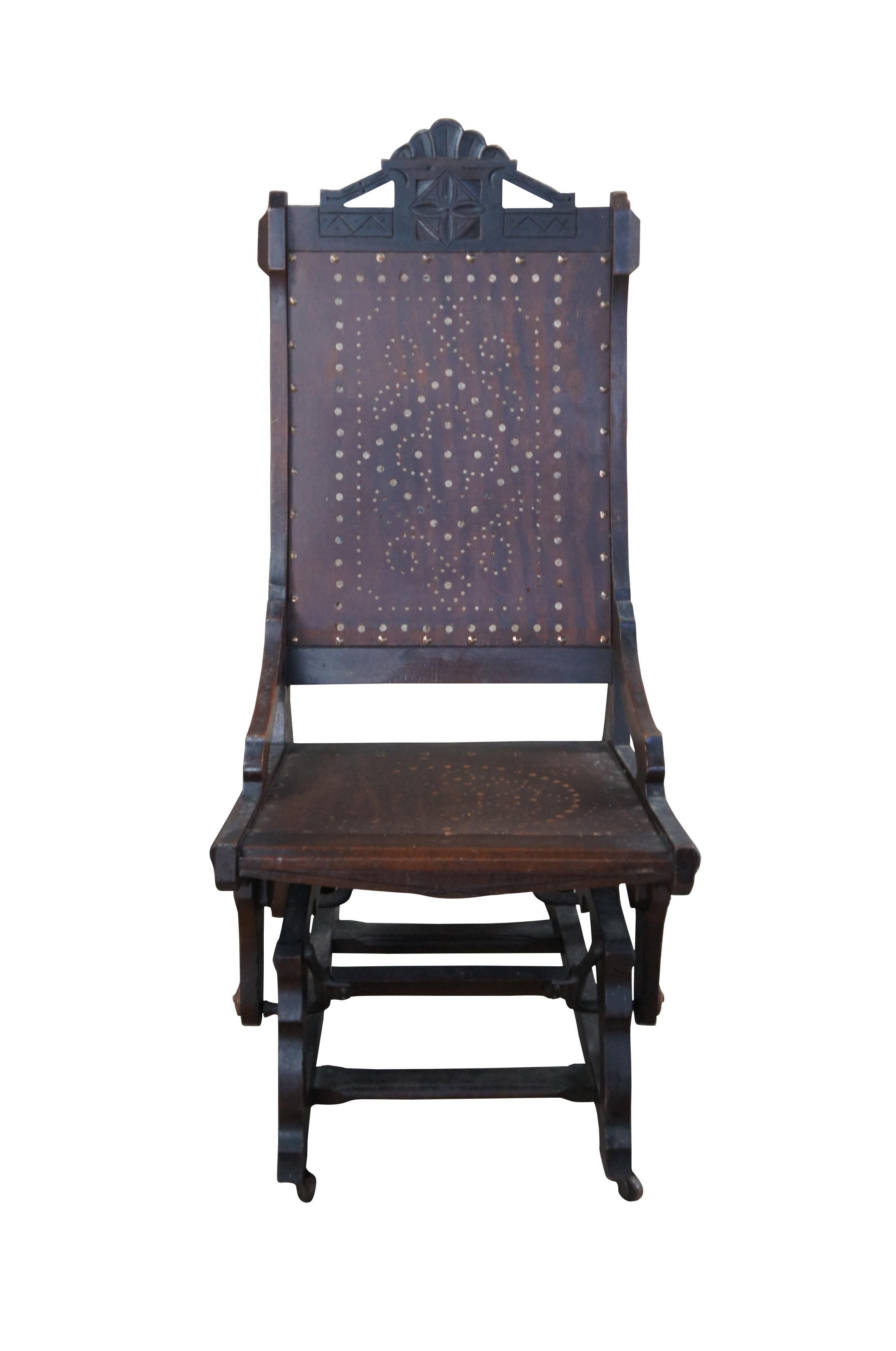 A lovely Aesthetic Era platform or gliding rocking chair by Lowentraut, circa 1876-1888.  Made from oak with a carved crest rail and unique Gothic style pierced seat and back.  

Dimensions: 
28