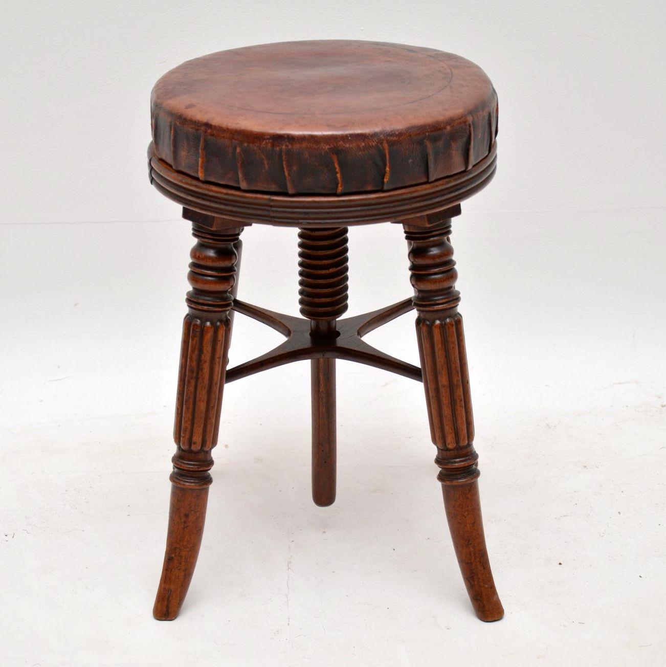 Antique Victorian mahogany adjustable piano stool with the original leather upholstery which is still in good condition for it's age and shows lovely character. The leather does show wear and natural ageing, but there are no holes or splits. This