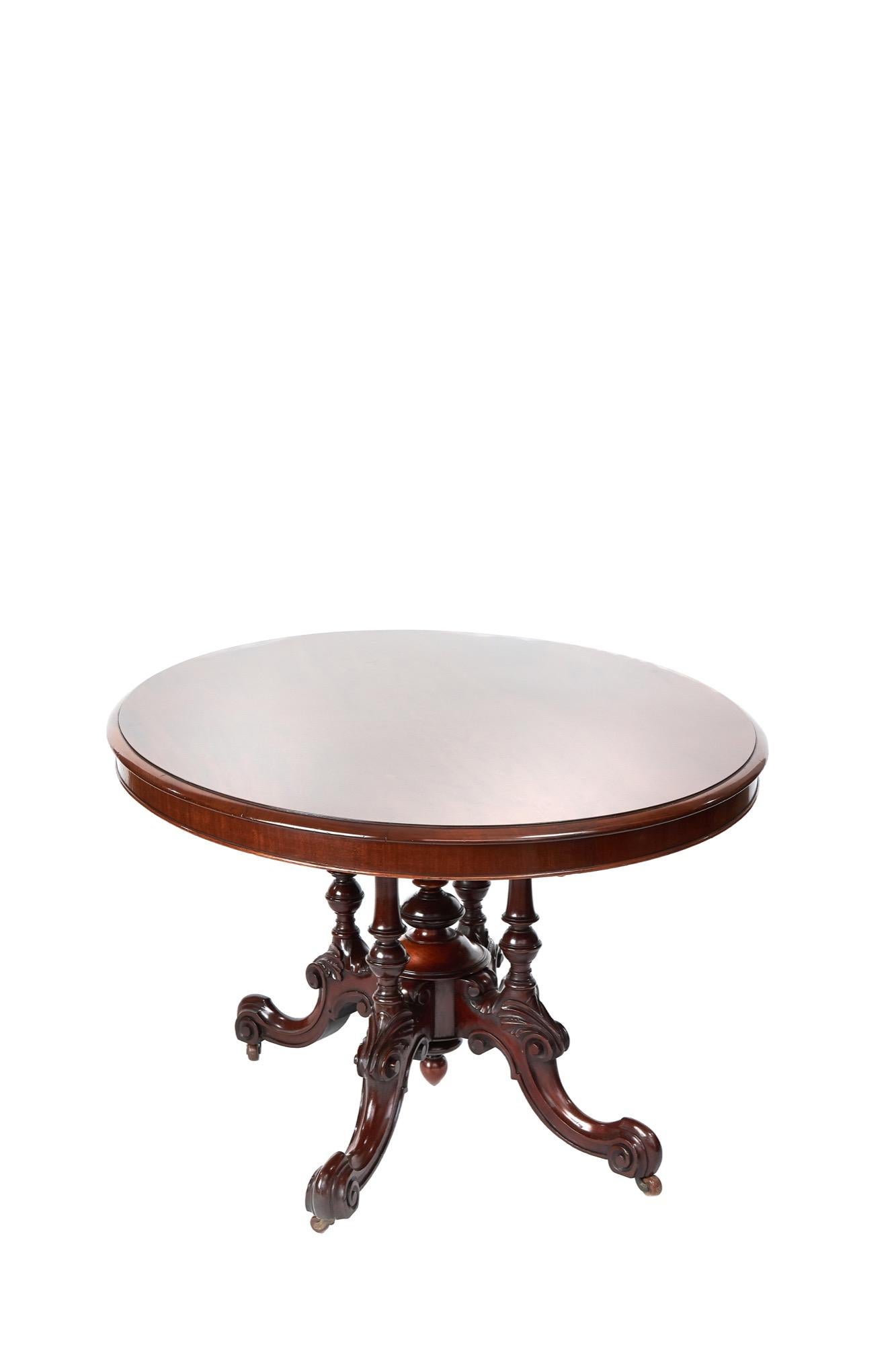 Antique Victorian mahogany centre table with a quadruple turned column base, supported by 4 cabriole legs, centre with turned finials.