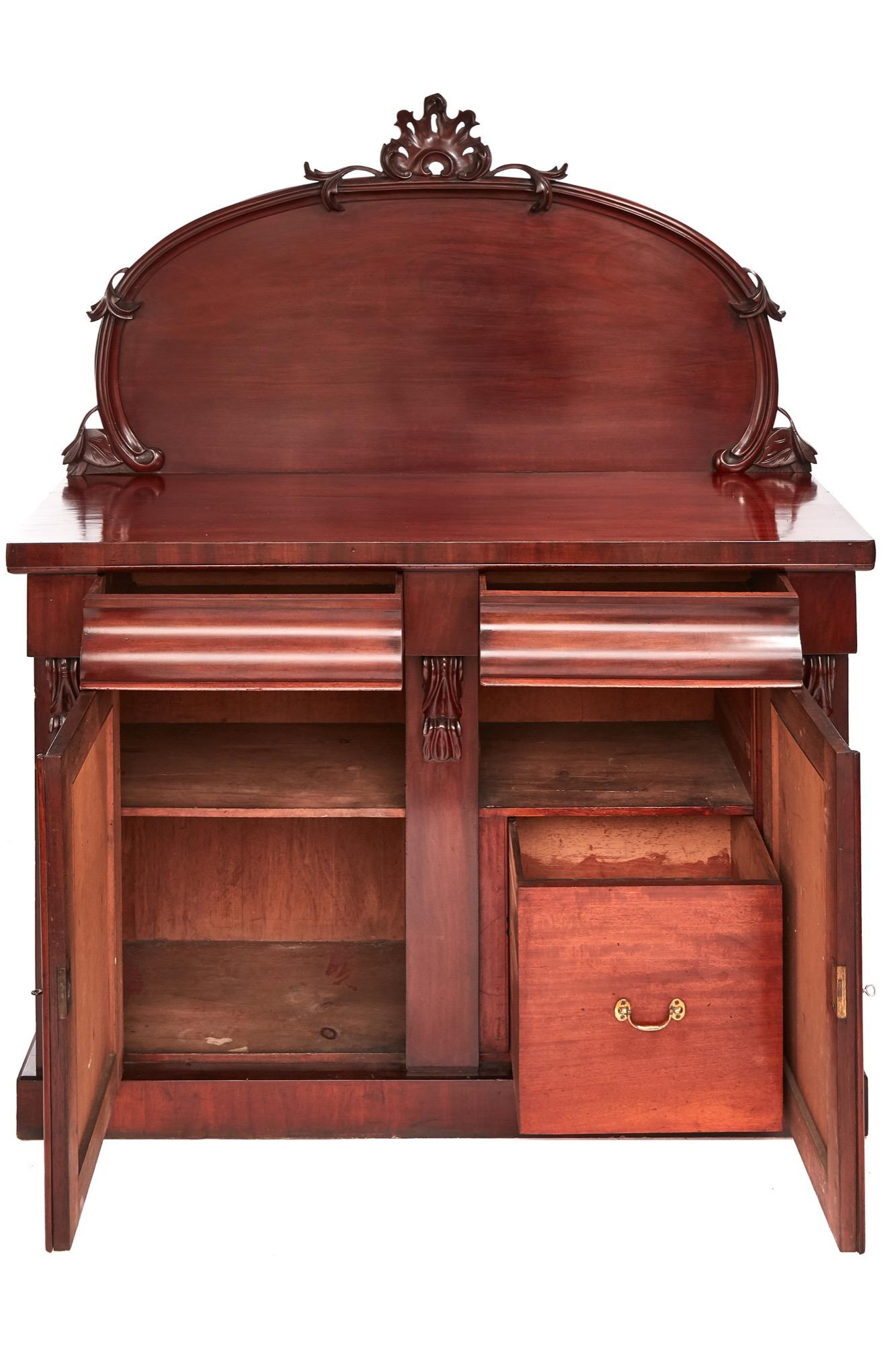 Quality Victorian mahogany Chiffonier with a charming carved rounded back, the base having two frieze drawers, two mahogany paneled doors with elegant carvings each side, fully fitted interior, standing on a plinth base.

This is in splendid