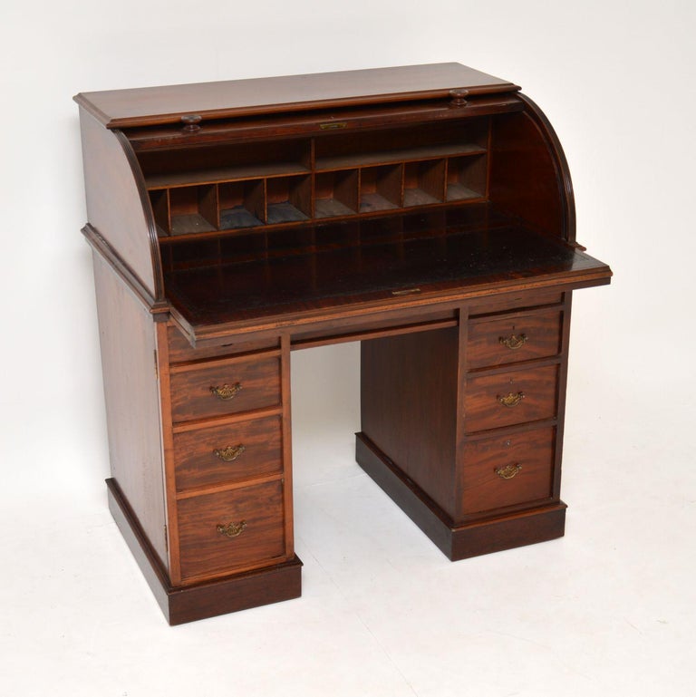 This antique Victorian mahogany cylinder top desk has nice small proportions and is in very good original condition with lots of character and a lovely warm color.

It’s finished and polished on the back also, so can be free standing and the top