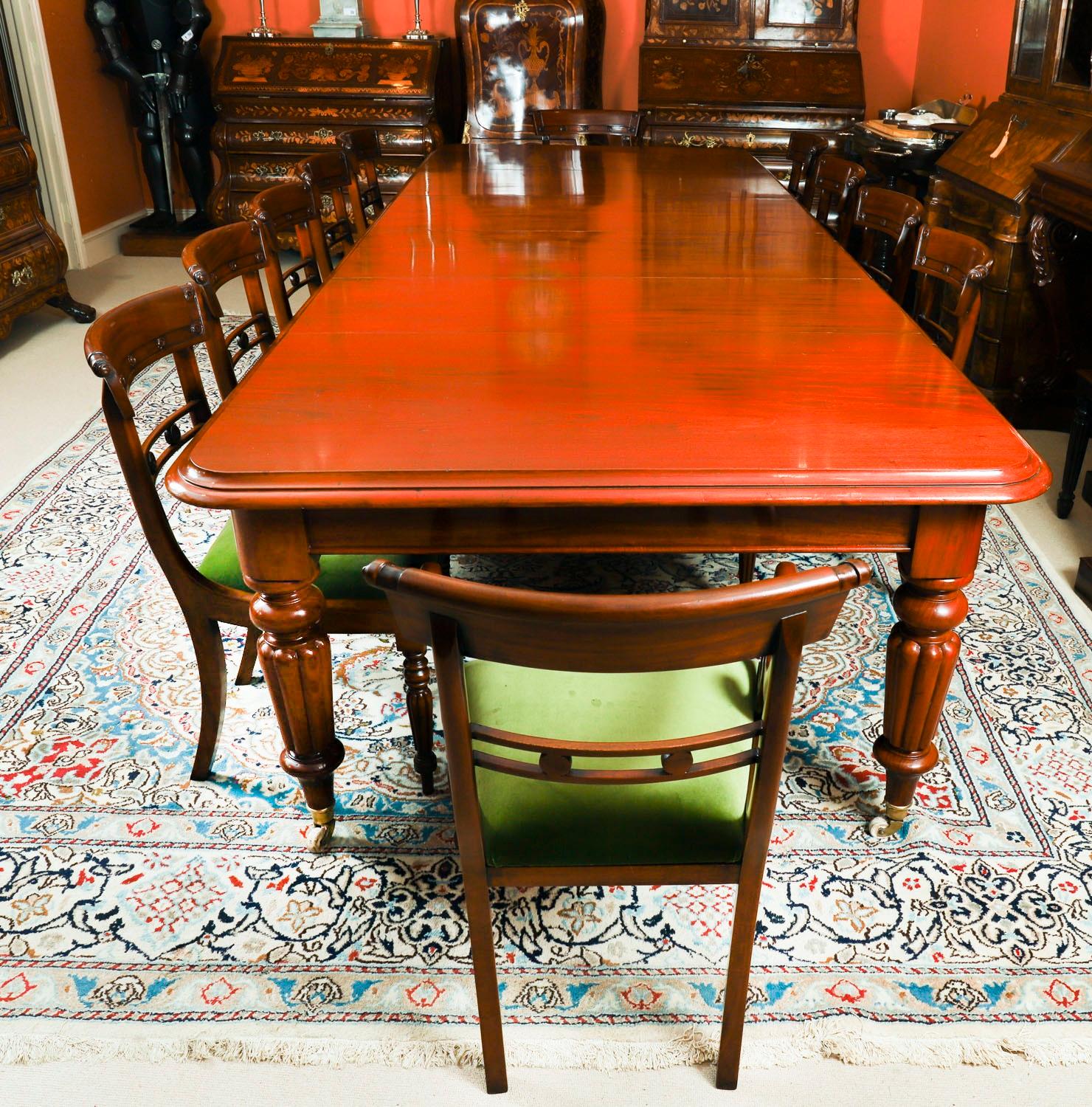 This is a fantastic dining set comprising an antique mid Victorian dining table, Circa 1860 in date, with a set of twelve bar back dining chairs, dating from the mid 20th century.

This beautiful table is in stunning  flame mahogany and has four