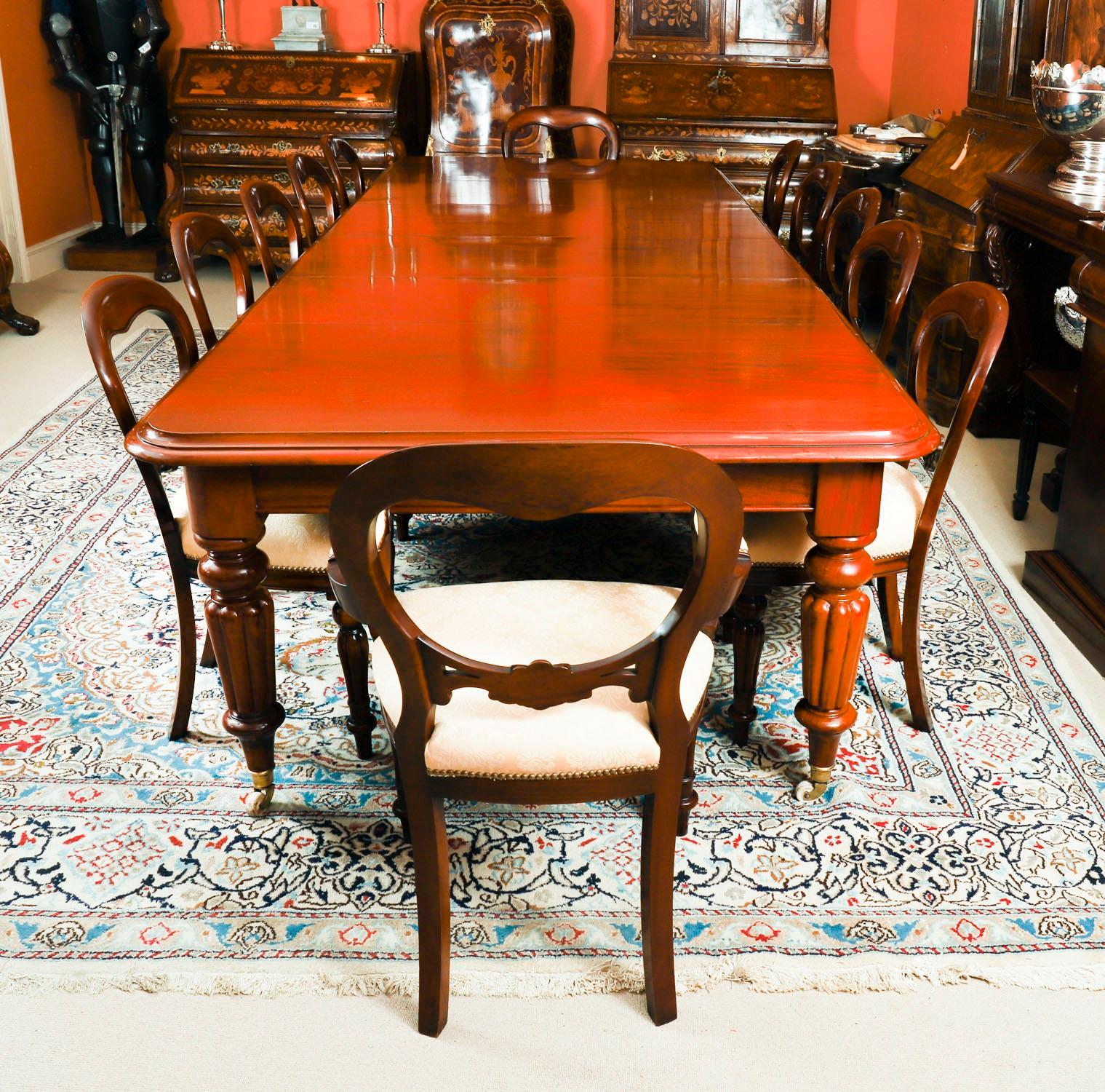 This is a fantastic dining set comprising of an antique  mid Victorian dining table, Circa 1860 in date, with a set of twelve balloon back dining chairs, dating from the last quarter of the 20th century.

The beautiful table is in stunning  flame