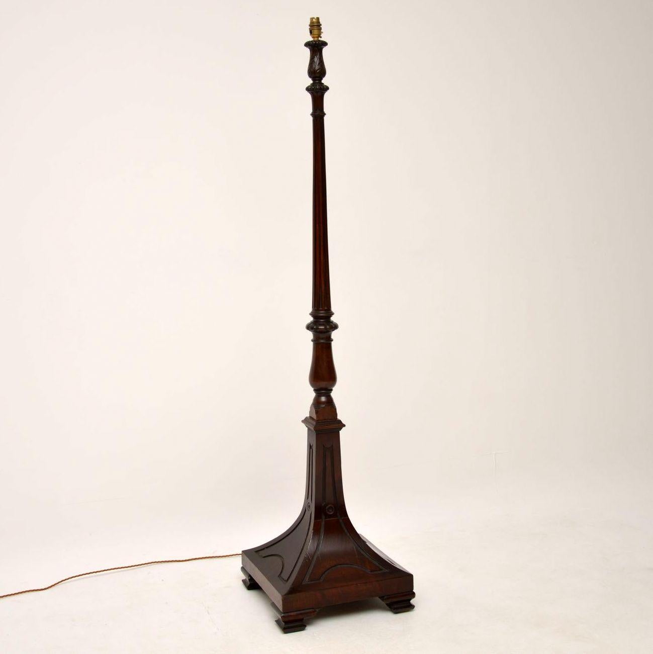 Antique Victorian mahogany floor lamp in good condition which has just been re-wired. It has a strong looking curved out square base with some interesting decoration and sitting on ogee bracket feet. Above that section is a turned upright carved at