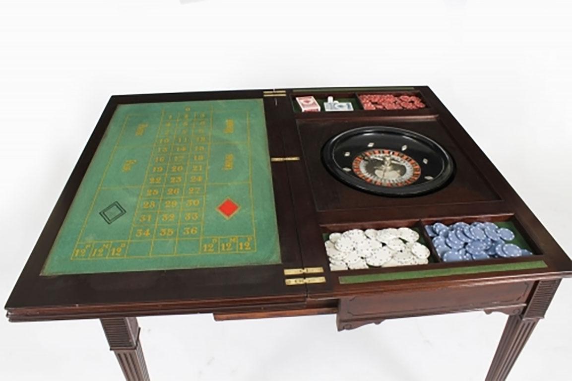 This is a fabulous and rare high quality antique Victorian mahogany metamorphic  triple top games table for cards and roulette, circa 1870 in date.

The hinged triple top opens to reveal the green baize lined gaming interior for playing cards with