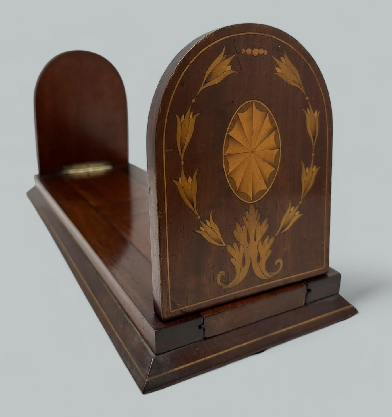 An Extremely well-constructed English Victorian Bookslide of good size proportions, mid Nineteenth Century, of outstanding quality and condition. The adjustable base raised on a plain spreading support with string inlay.  

Each hinged folding