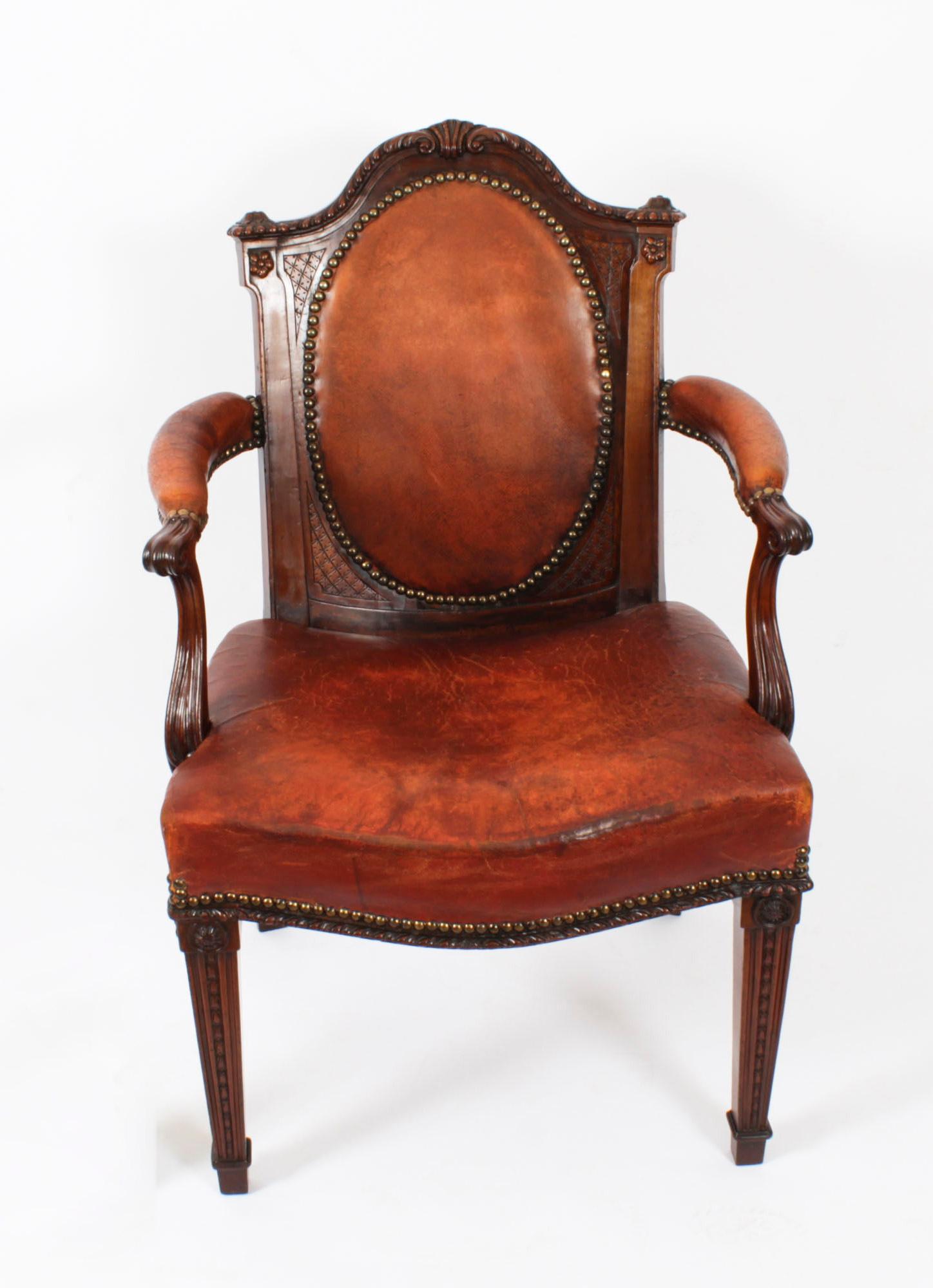 This is a fantastic antique Victorian Mahogany desk armchair, circa 1860 in date.

Expertly made out of superbly carved mahogany, with stuff over seat and an oval padded back that features its sumptuous original caramel leather.

The shaped arms
