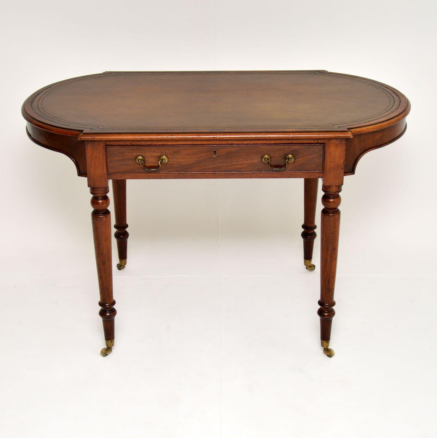 A fantastic original Victorian period writing table in mahogany, with an inset leather top. This dates from circa 1850-1860 period.

This has an unusual oval shape design, it is of amazing quality and is wonderful condition for its age. We have