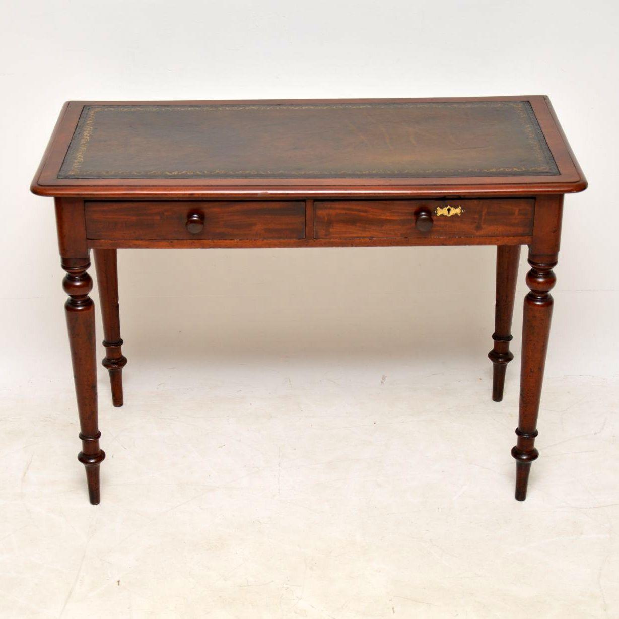 Fine quality antique Victorian mahogany writing table with a tooled leather writing surface. It's in good original condition and has lots of character, with a lovely warm original color. There are two drawers with mahogany handles and fine