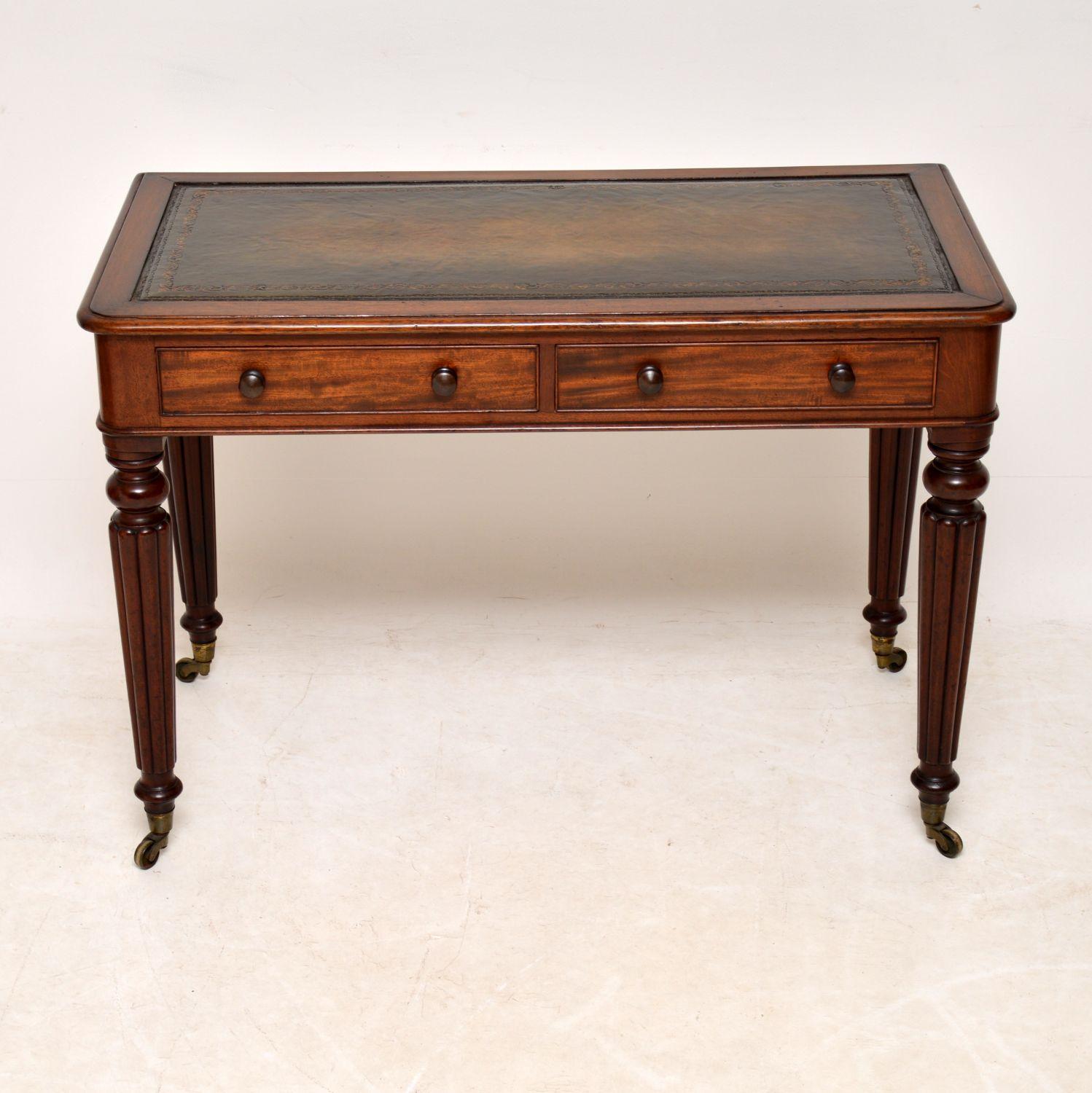 Fine quality antique Victorian mahogany writing table in excellent original condition. Dating to circa 1860s period, it has a polished back, so can be free standing. It has a hand colored tooled leather writing surface, two drawers, with turned