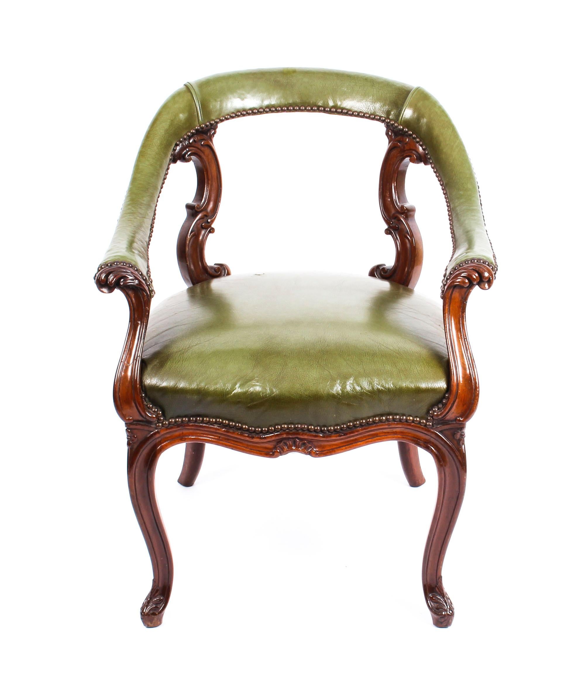 This is an impressive antique Victorian mahogany library chair, circa 1860 in date.

This sturdy and very refined elbow chair is upholstered in beautiful green leather and is exquisitely studded.
 
It features an attractive moulded scrolling