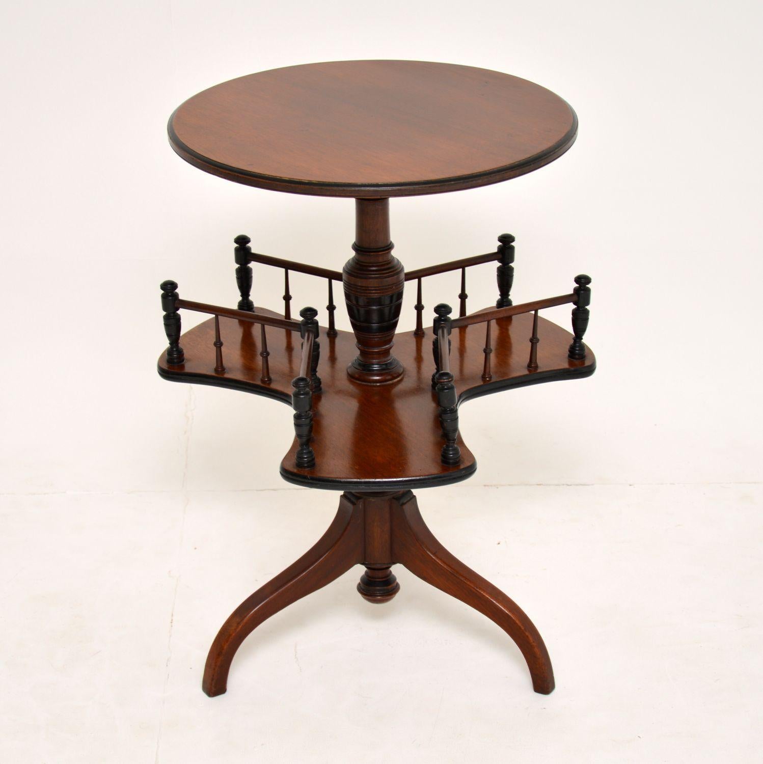 Antique Victorian mahogany occasional table with a circular top and a revolving galleried section in the middle. It’s in very good original condition and I would date it to circa 1880s period.

Please enlarge all the images to see up close all the
