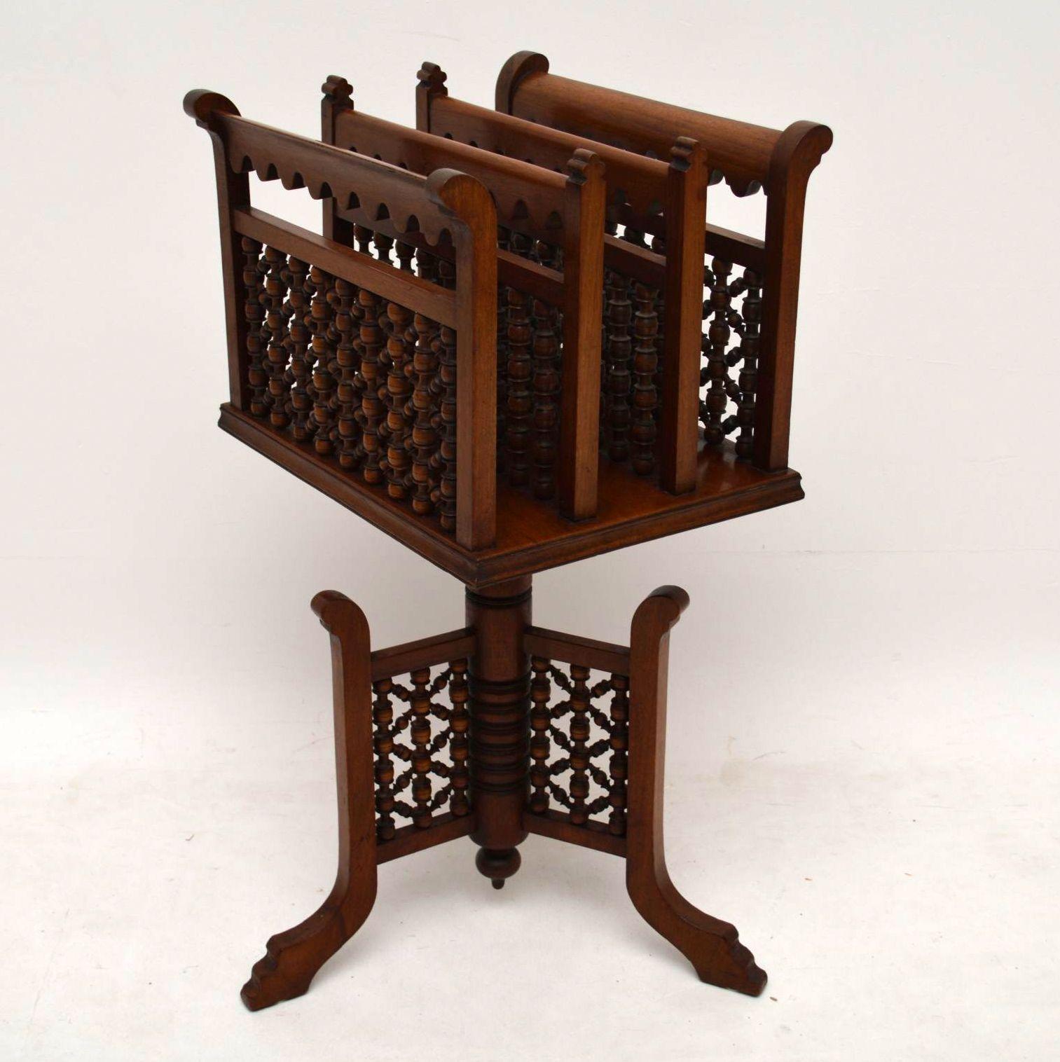 Antique revolving mahogany Canterbury (book or magazine rack), in good original condition and of a very distinct style. It’s 19th century and probably colonial. There are three very decorative compartments on the top section with lots of turned