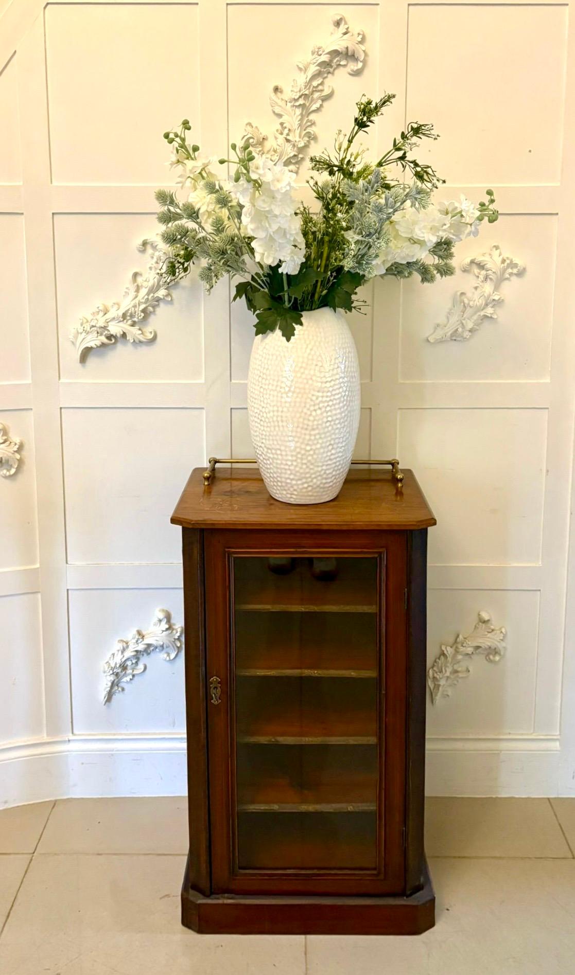 An elegant mid-to-late 19th century Victorian mahogany sheet music cabinet of fine quality and rich colour featuring a single glazed door opening to reveal a series of five fixed interior shelves each with its original gilt-tooled leather front