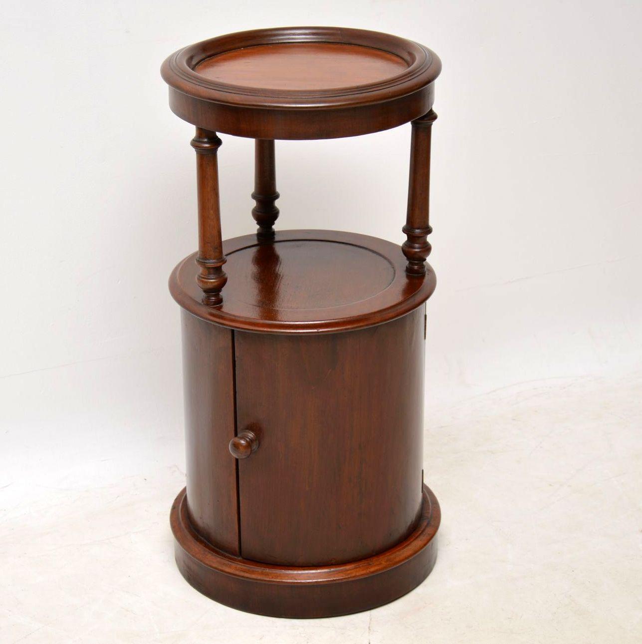 Antique Victorian cylindrical shaped mahogany side table with a cupboard base. It’s quite an unusual piece and very useful too. I suppose the top section could be used as a stand for a plant or a sculpture. The top is supported by three turned