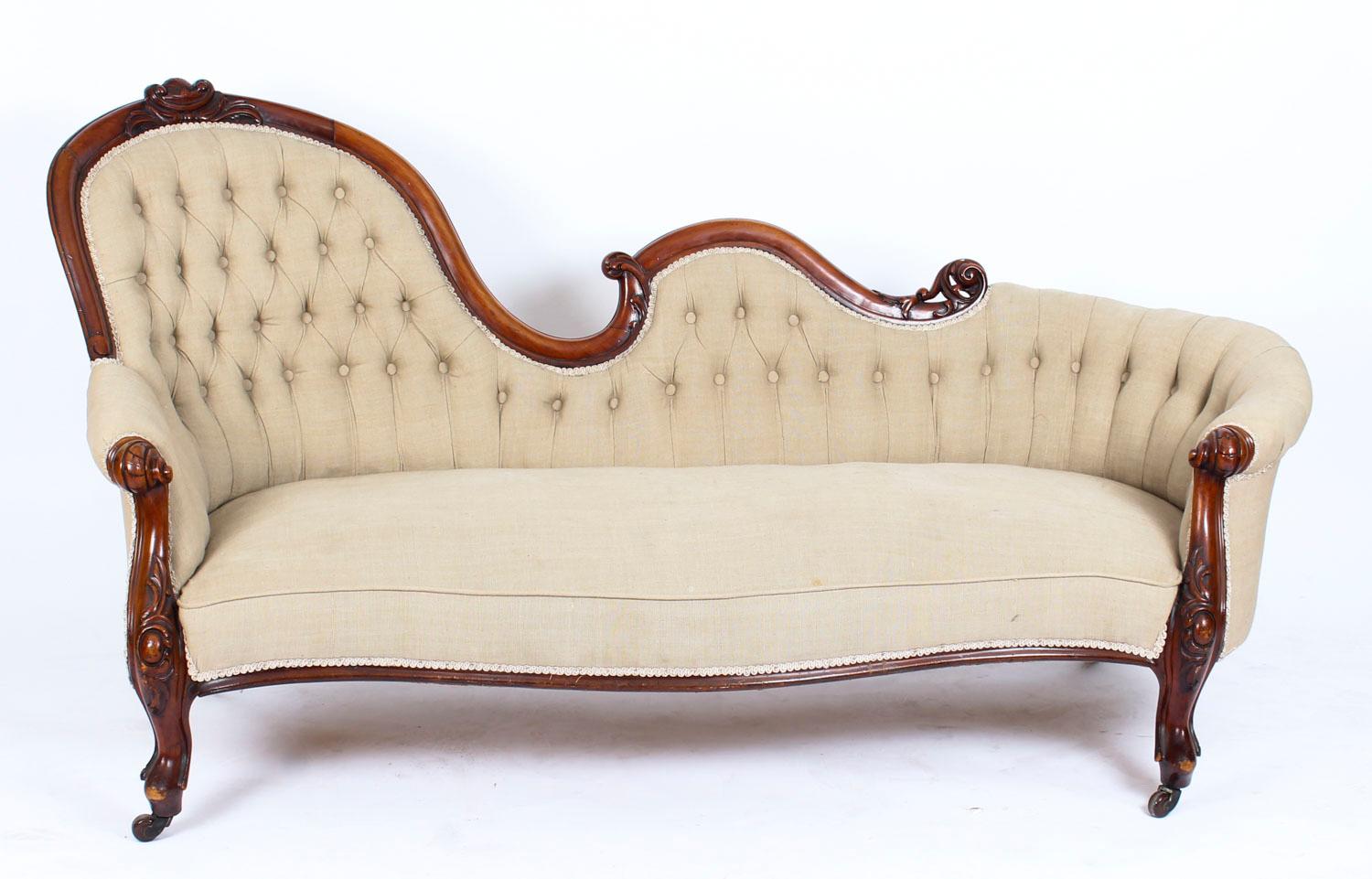 This is a gorgeous English antique Victorian chaise longue which dates from circa 1860.

This sofa was made from hand carved solid mahogany with an undulating and scrolled top-rail enclosing deep-button upholstered back and sides above a serpentine