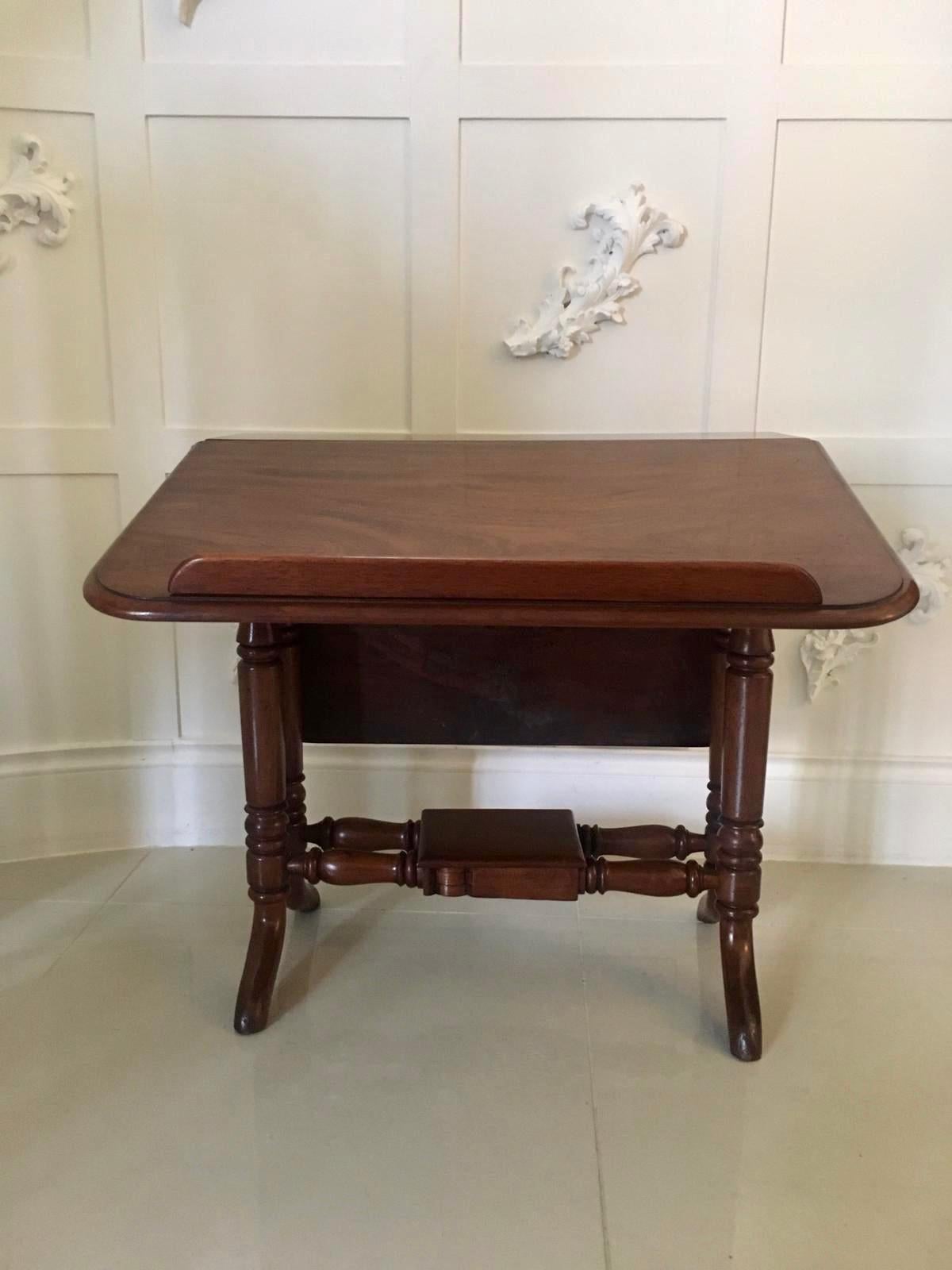 Unusual antique mahogany Sutherland reading table having a quality top with two drop leaves one can be raised to provide a reading stand. It has a thumb moulded edge and is supported by 4 turned mahogany columns with splayed feet, united by four