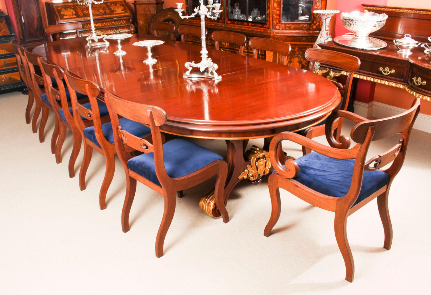 A fantastic antique Victorian dining set comprising an antique Victorian mahogany and gilded twin pedestal base dining table by the renowned Glasgow cabinet maker and retailer Wylie & Lochhead, Circa 1850 in date and a set of twelve Regency period