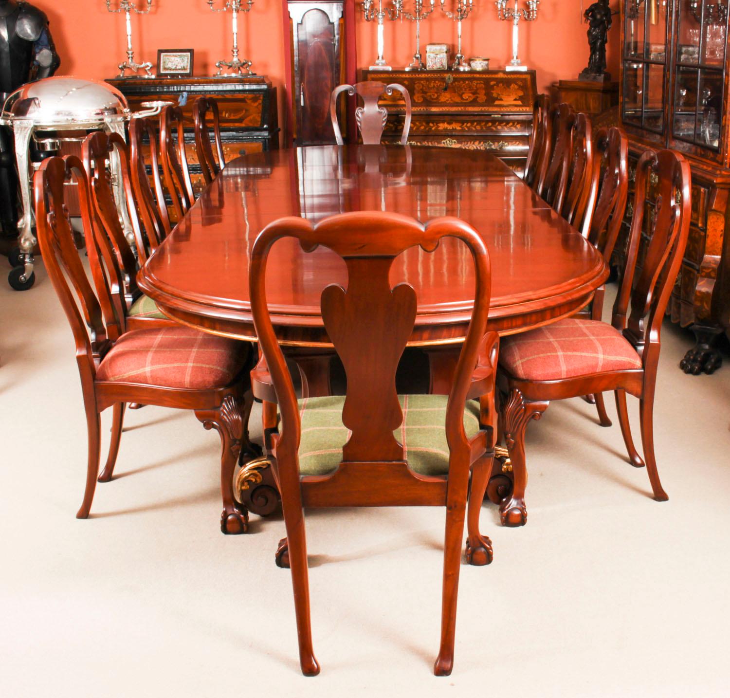 A fantastic antique Victorian dining set comprising an antique Victorian mahogany and gilded twin pedestal base dining table by the renowned Glasgow cabinet maker and retailer Wylie & Lochhead, Circa 1850 in date and a set of twelve Queen Anne