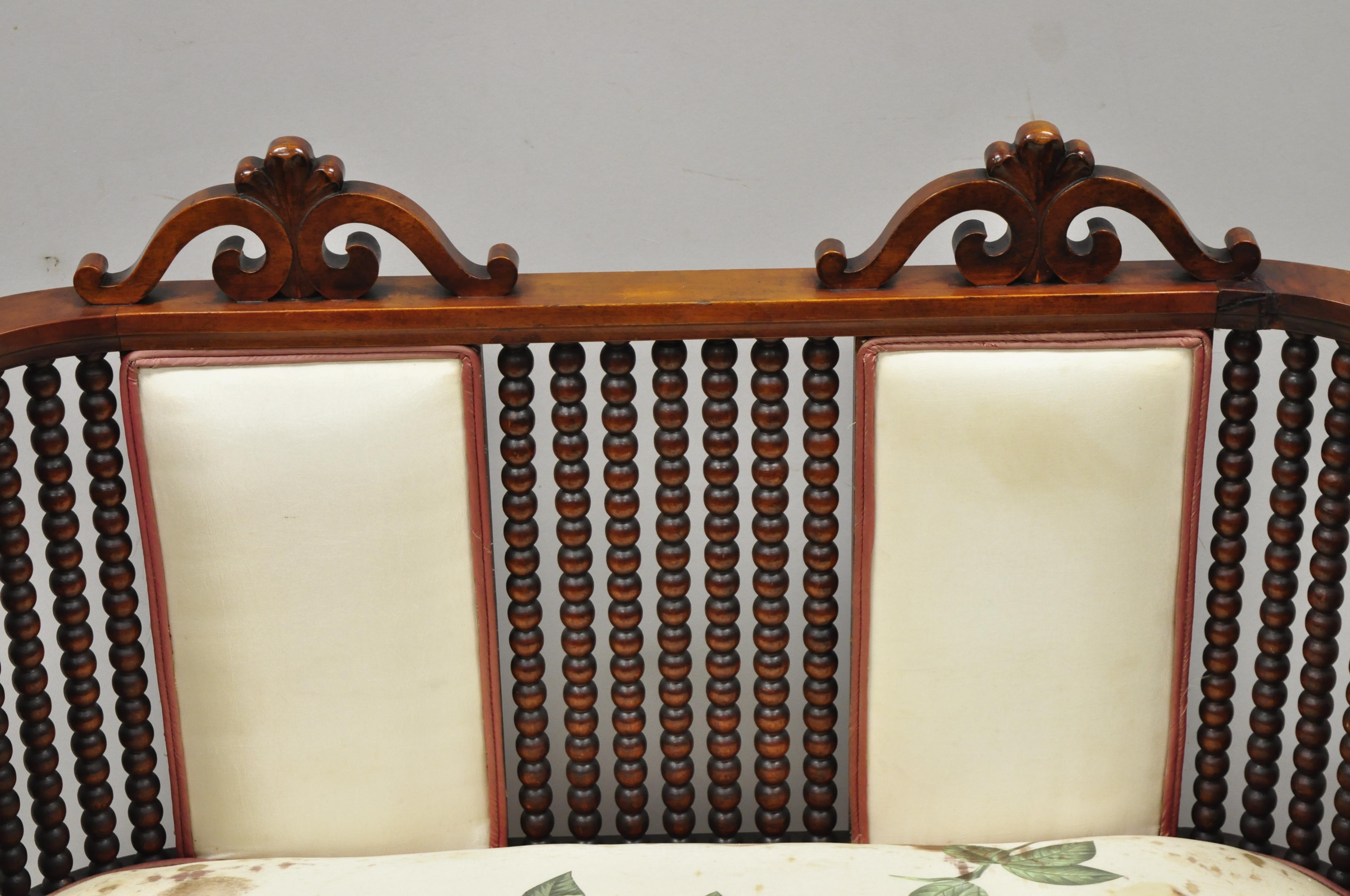 Antique Victorian mahogany upholstered Victorian spool spindle bench loveseat. Item features 