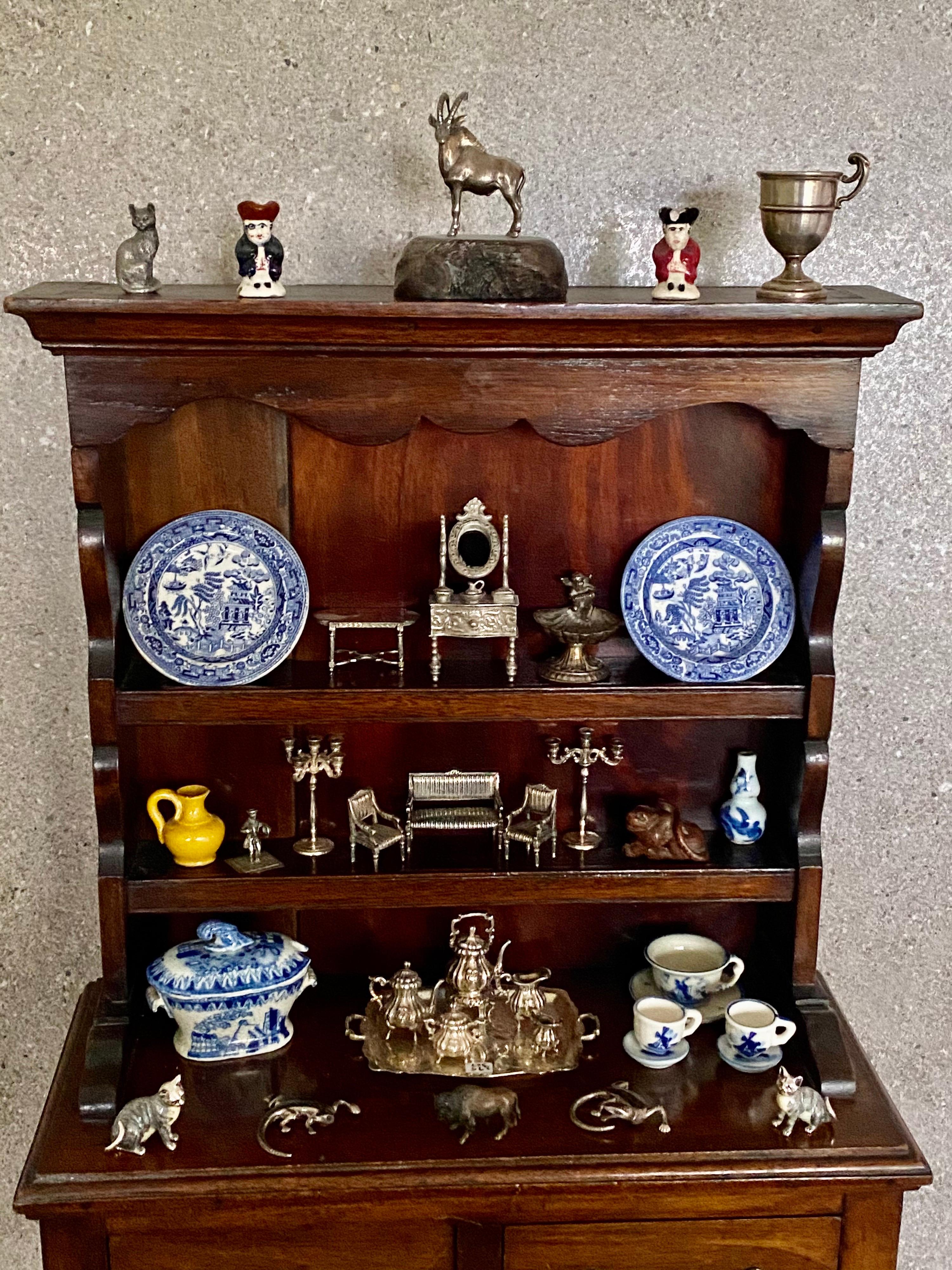 A beautiful Victorian miniature apprentice piece in the form of a dresser two drawers below open display shelves Veneered in superb quality 4mm mahogany veneers In a lovely rich colour and patination. Original brass handles. Nice condition split in