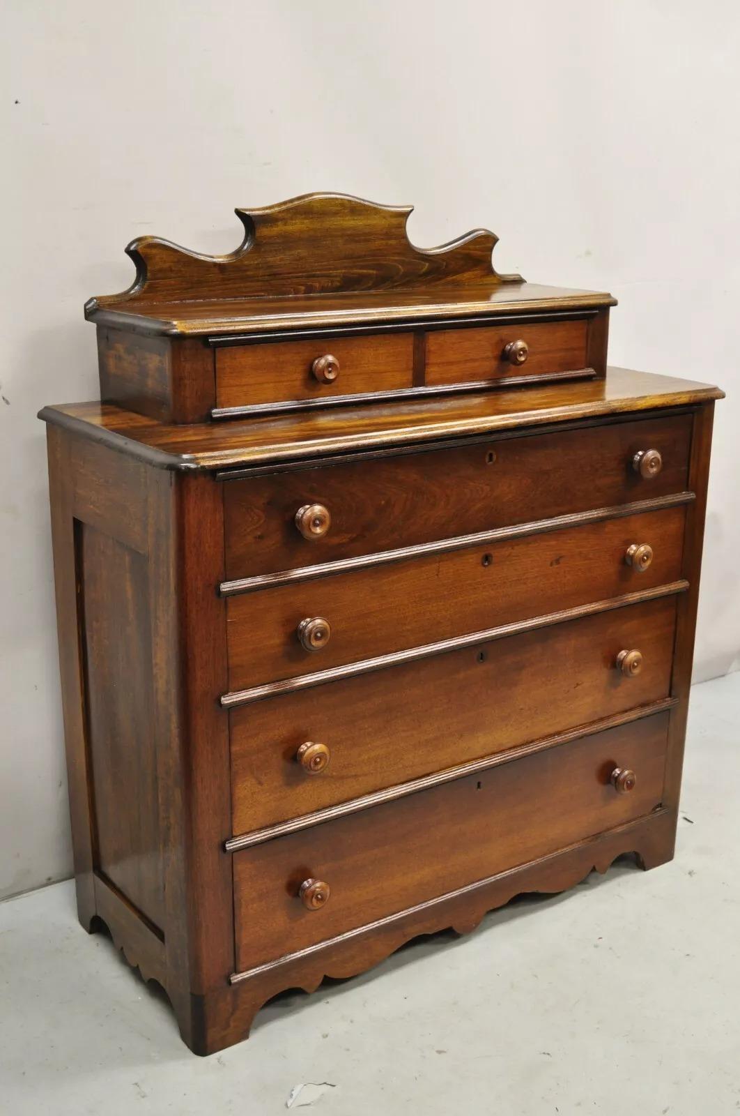 Antique Victorian Mahogany Wood Step Back Glove Box Chest on Chest Dresser with Backsplash. Item features 6 drawers with cove and pin joint construction, working lock and key, beautiful wood grain, Circa Late 19th Century. Measurements: 47.5