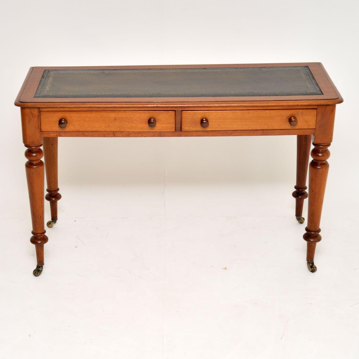 This antique Victorian mahogany writing table has slim proportions from back to front, so could well suit certain areas with limited space.

It has a tooled leather writing surface, two drawers with turned bun handles and turned legs with brass