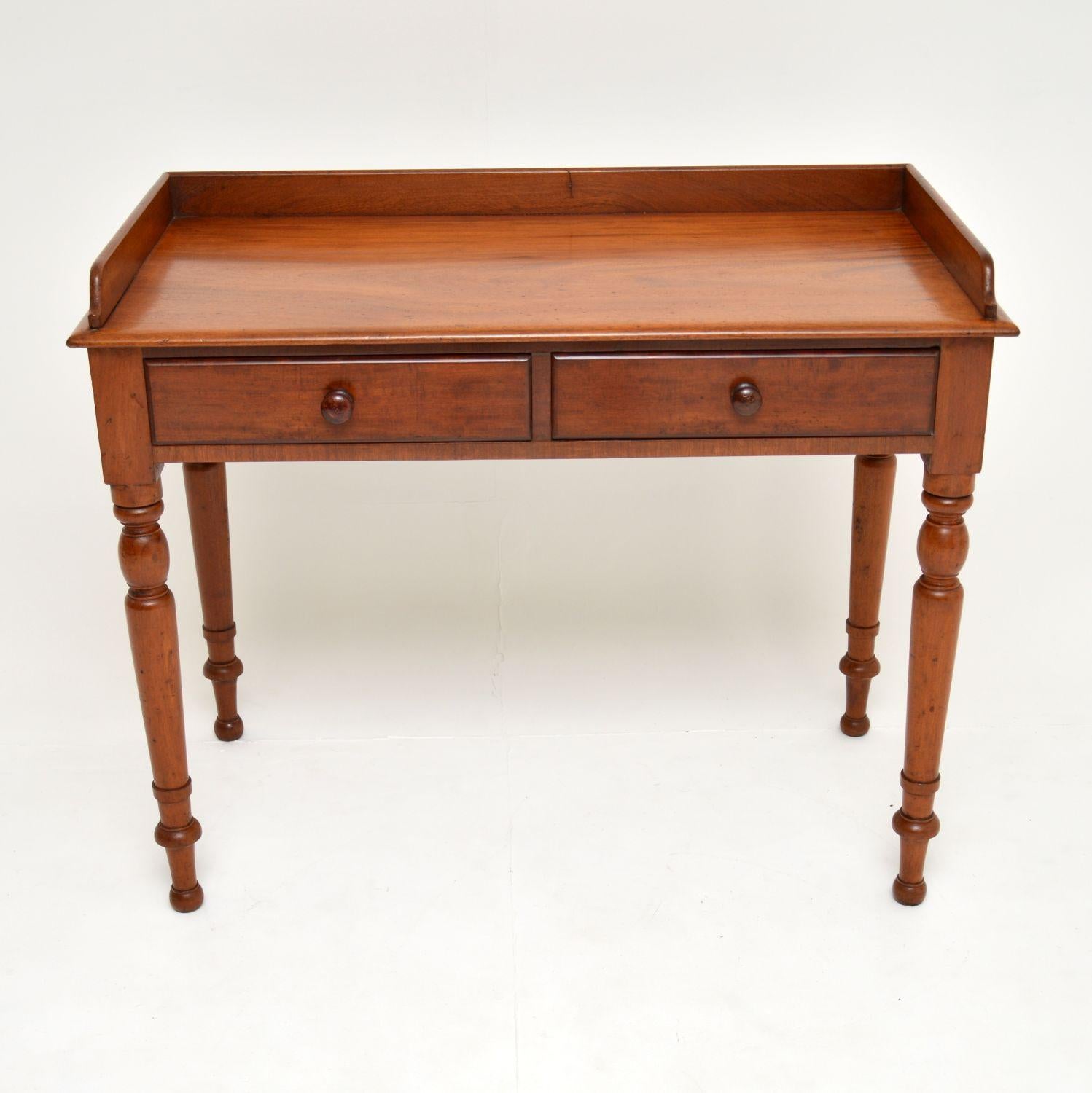 A lovely antique Victorian writing table in solid mahogany, this dates from circa 1860-1880 period.

It is of great quality and nice proportions. There is a gallery on the back and sides, solid mahogany writing surface and beautifully turned legs